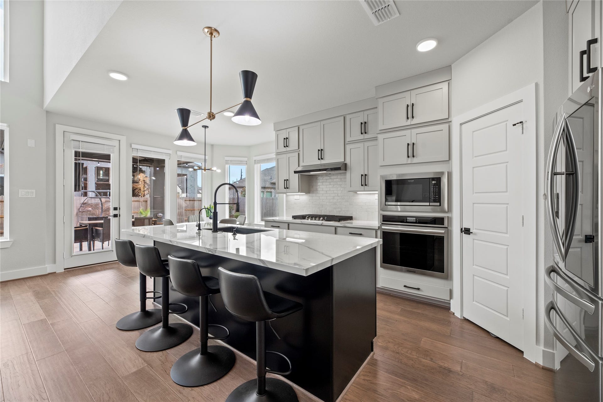 Your chef-inspired kitchen is ready to impress! This beautifully designed space features a sprawling island with breakfast bar, porcelain countertops and pendant lighting.