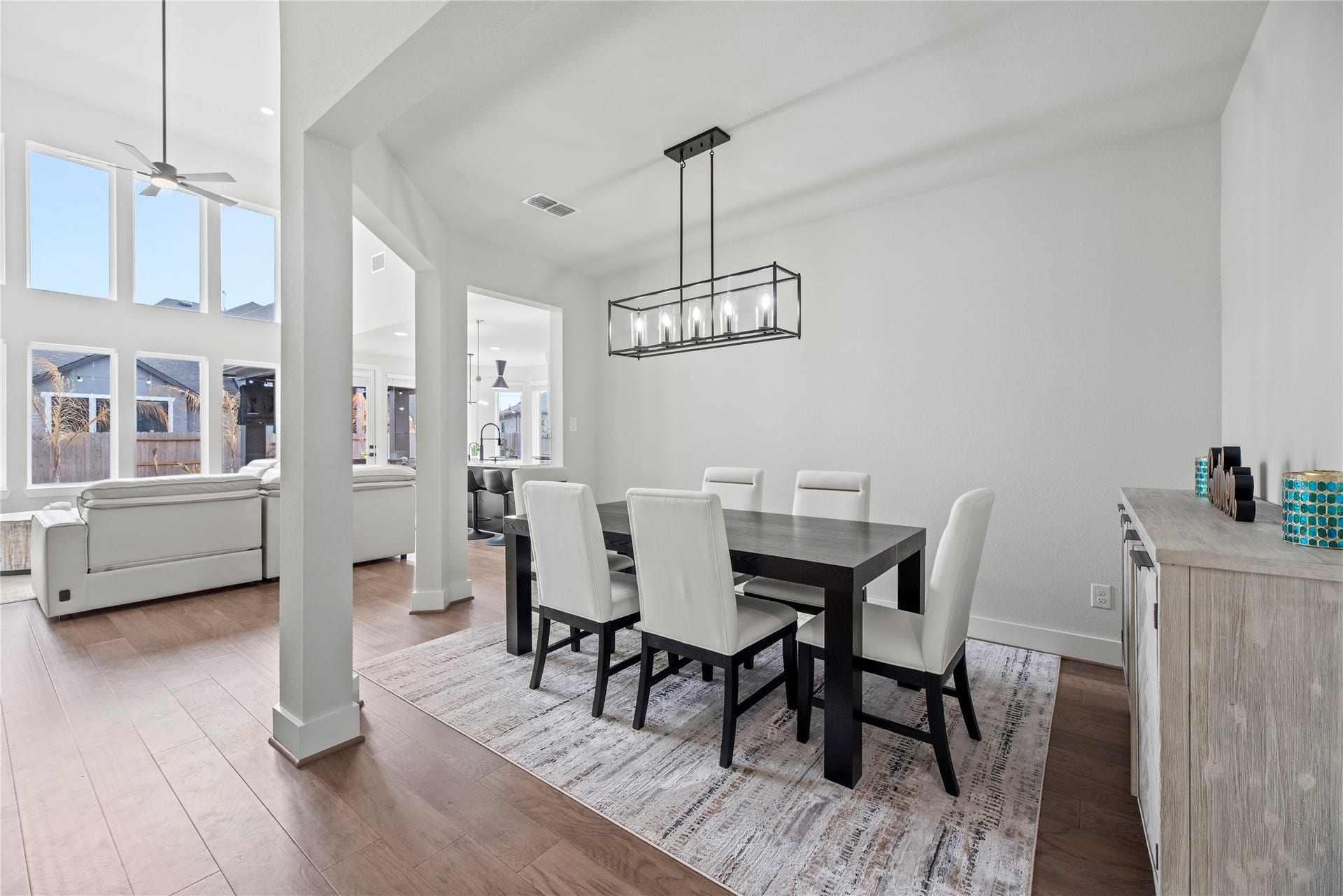To the right of the entry is your formal dining space. Designer lighting can truly elevate the ambiance and aesthetic of a space, adding both functionality and style.