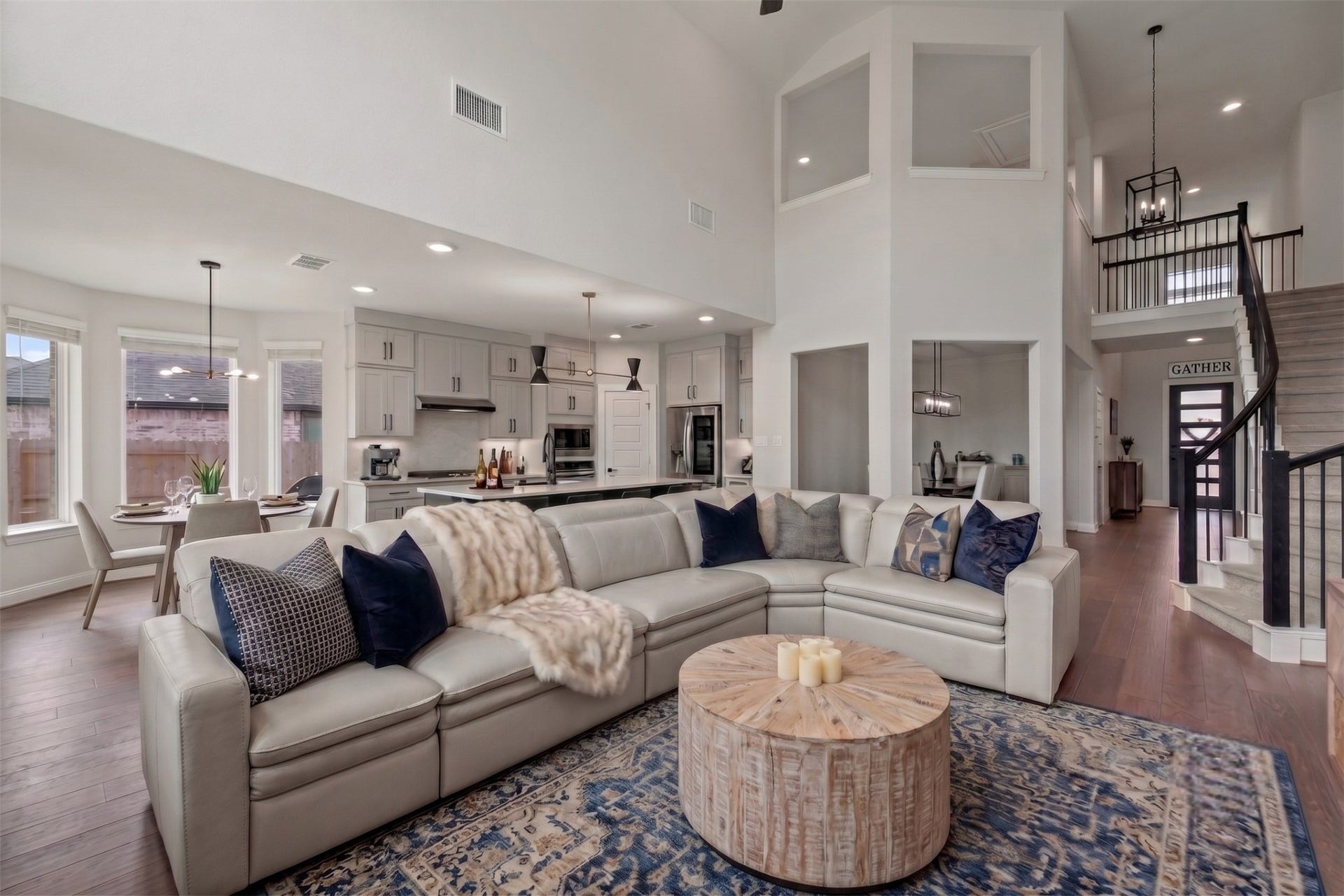 The open-concept design thoughtfully connects the living, dining, and kitchen areas, creating a seamless and versatile space. Virtually staged.