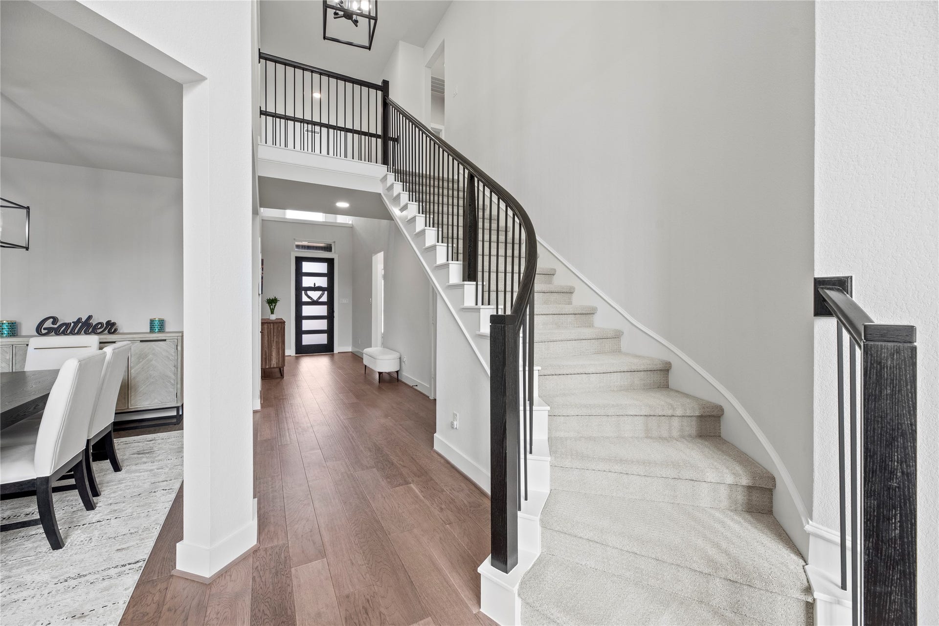 Even the staircase exudes elegance, featuring a harmonious blend of neutral hues and exquisitely crafted designer iron spindles.