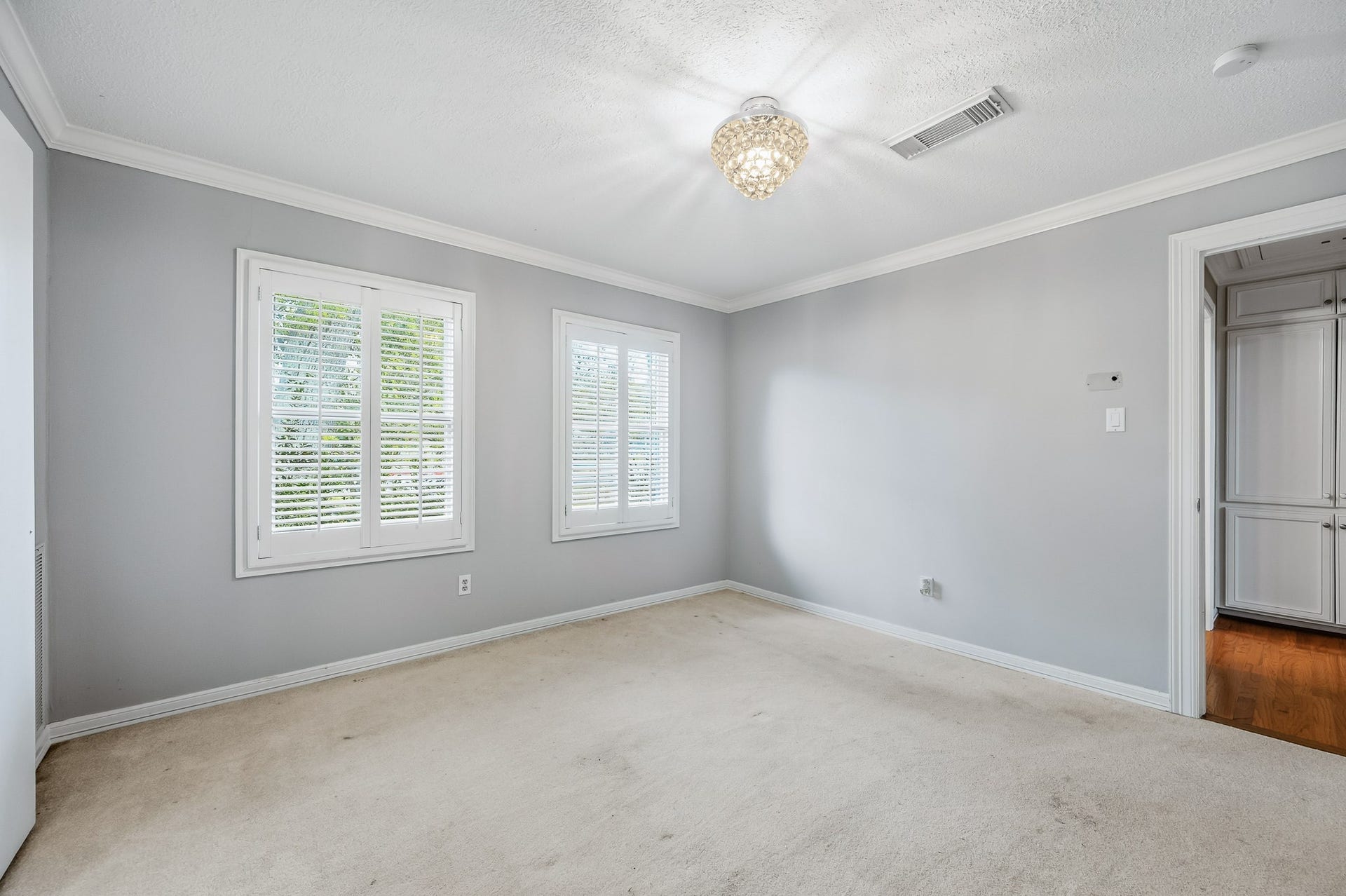2111 N Galveston Avenue, Pearland, TX 77581 This is second bedroom towards the middle of home located in hall off of the kitchen area with a bathroom in the hall as well.