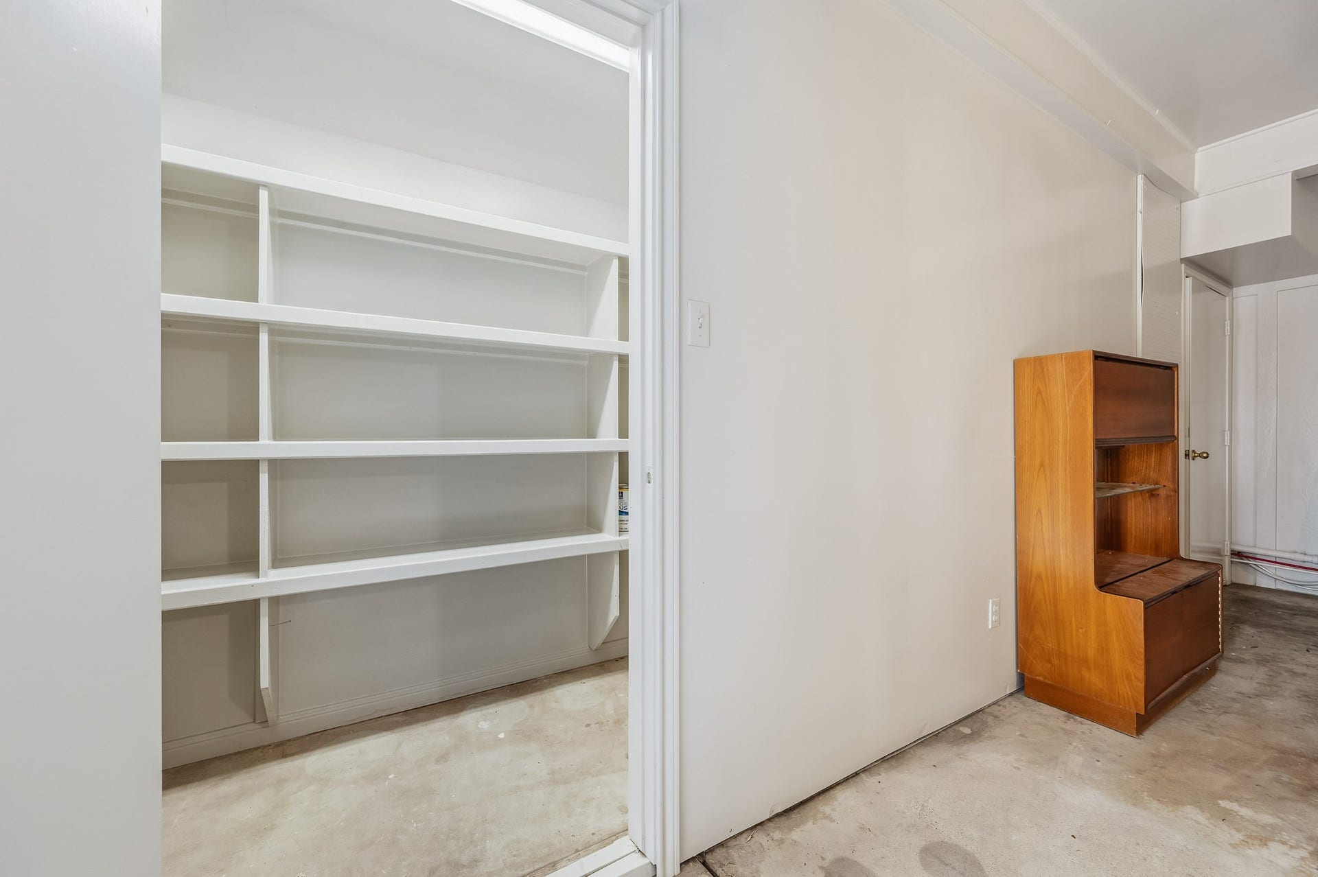 2111 N Galveston Avenue, Pearland, TX 77581 This oversized garage offers extensive cabinet shelving and storage, perfect for anyone who loves to stay organized and well stocked.