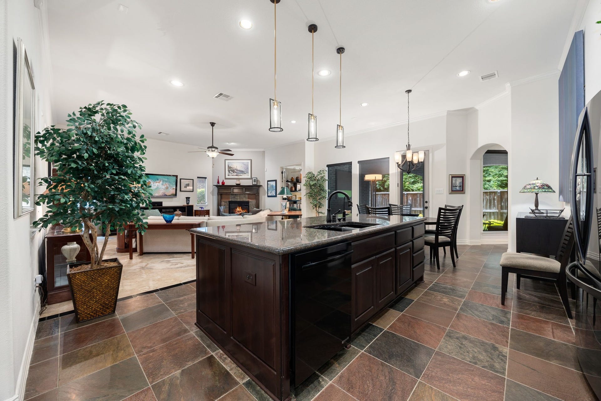 195 Oarwood Place, The Woodlands, TX 77389 The kitchen and living room are connected by a thoughtful flooring design that defines each space while keeping the open layout bright and inviting.