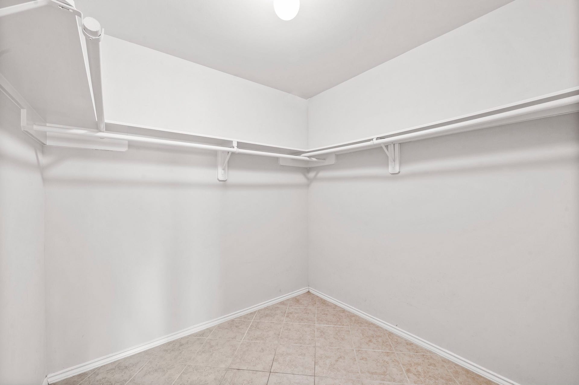 6322 Sunlit Orchard Drive, Houston, TX 77072 Spacious walk-in closet with ample shelving and hanging space, perfect for organizing your wardrobe.