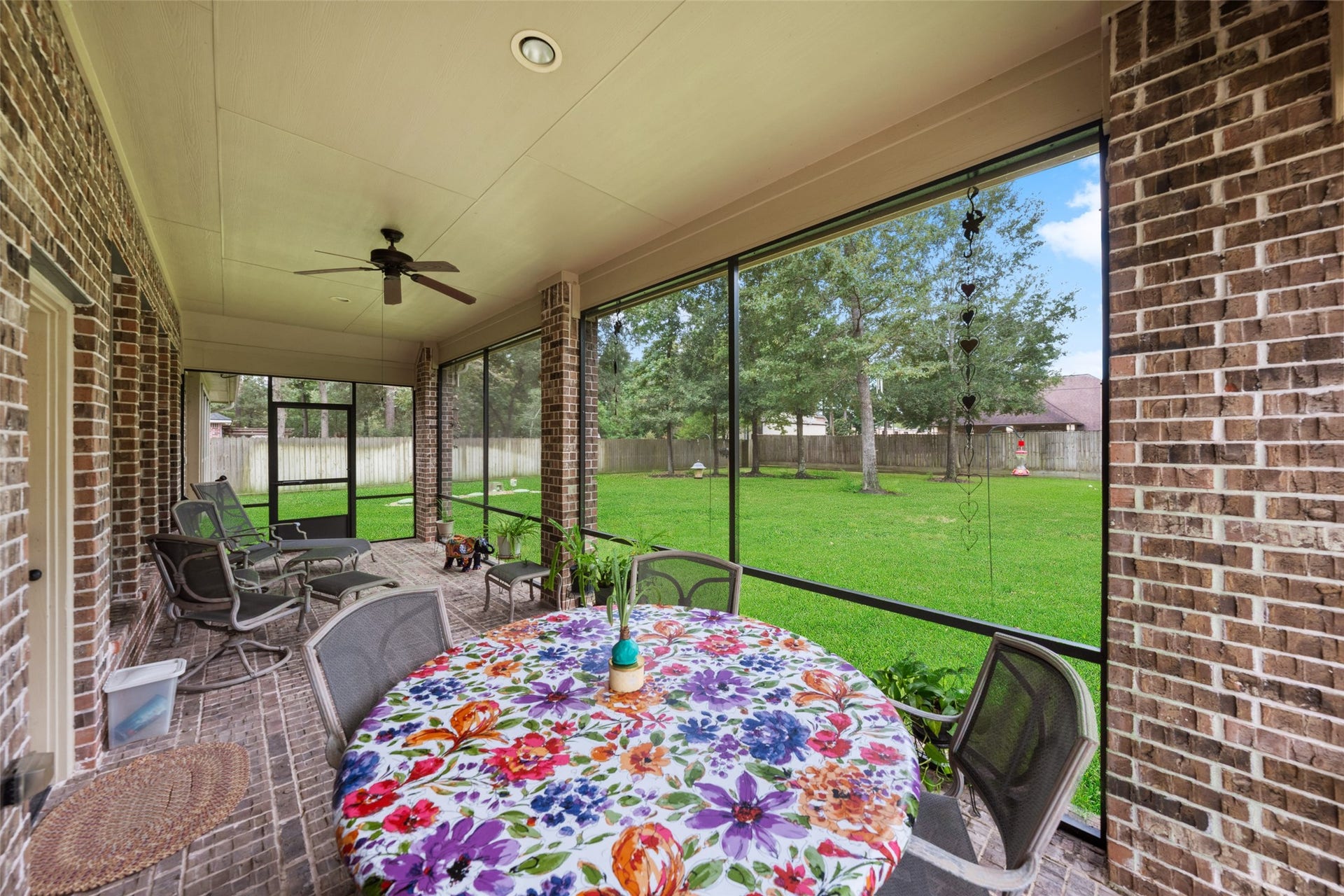 903 Weeping Willow Way, Magnolia, TX 77354 Spacious screened-in patio overlooking fully fenced backyardperfect for outdoor relaxation and entertaining.