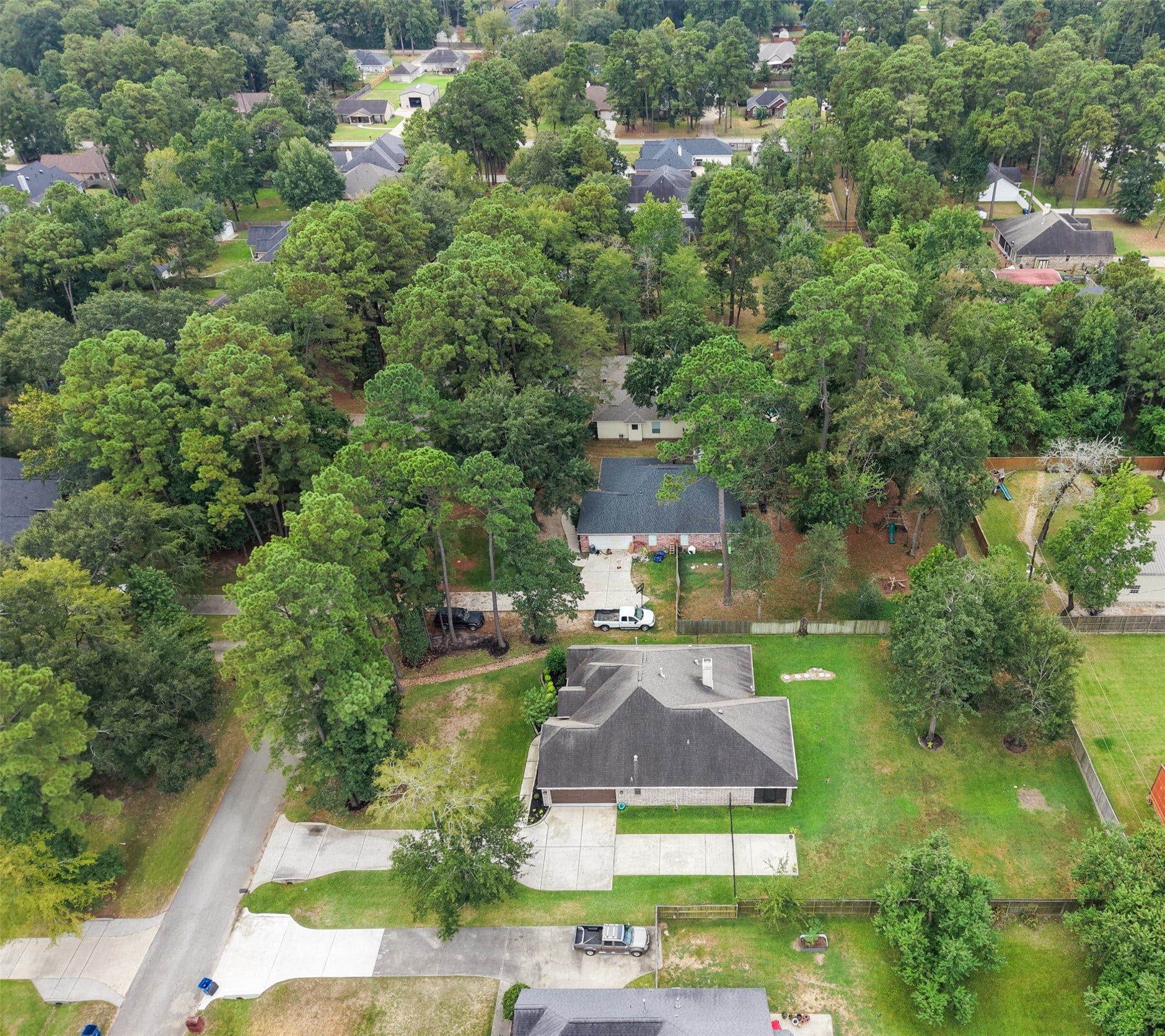 903 Weeping Willow Way, Magnolia, TX 77354 Nestled in wooded Westwood neighborhood, this home offers spacious 100x200 feet lot and a serene setting with abundant wildlife, perfect for privacy and outdoor enjoyment. This view shows the driveway extension.