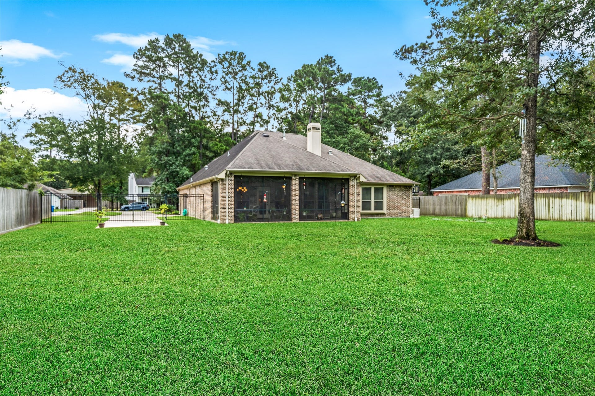 903 Weeping Willow Way, Magnolia, TX 77354 Expansive backyard and mature trees and a screened porch perfect for outdoor relaxation. The driveway was extended and drip system septic planned for addition of future shop