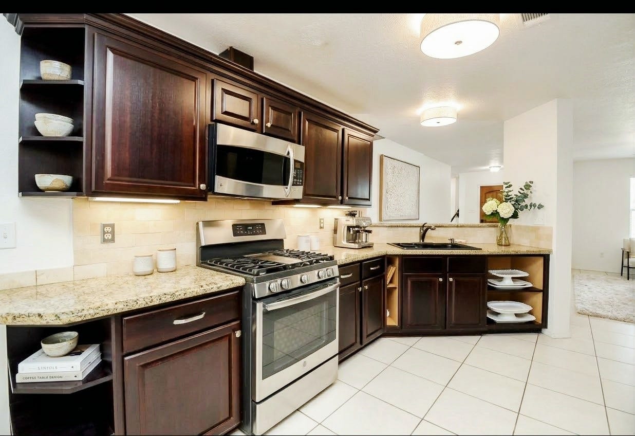 Kitchen has stain-steel appliances and beautiful cabinetry *Virtualy staged