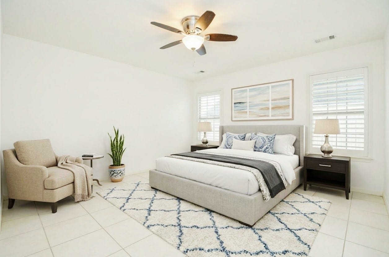 Master bedroom with ceiling fan and ample lighting *Virtually staged