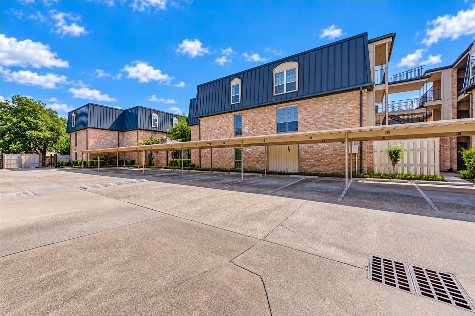 Charming courtyard setting with a beautifully landscaped garden, featuring a central fountain and brick pathways, perfect for relaxation and outdoor enjoyment.