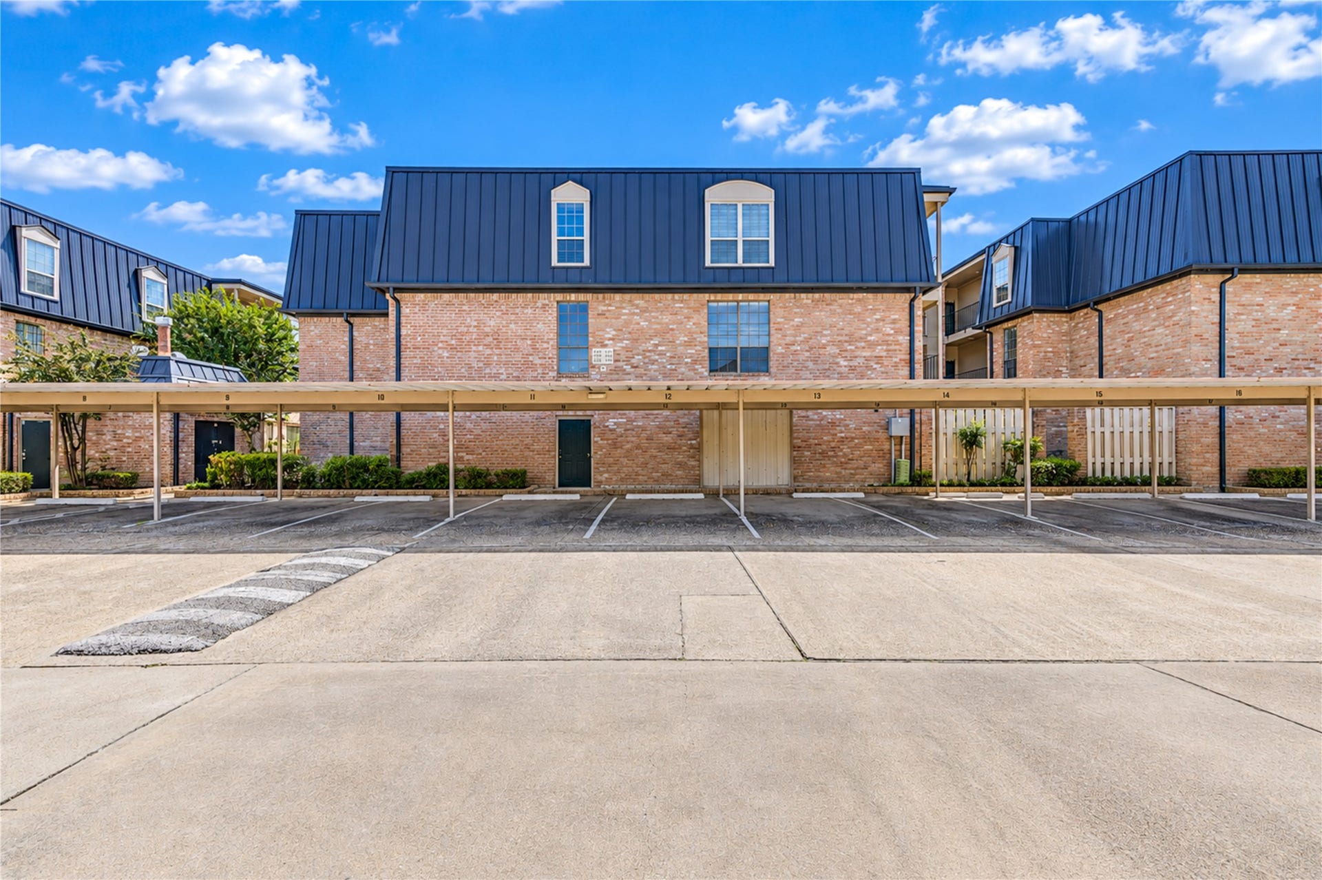Charming courtyard with lush greenery, brick pathways, and cozy seating areas, perfect for relaxing outdoors.