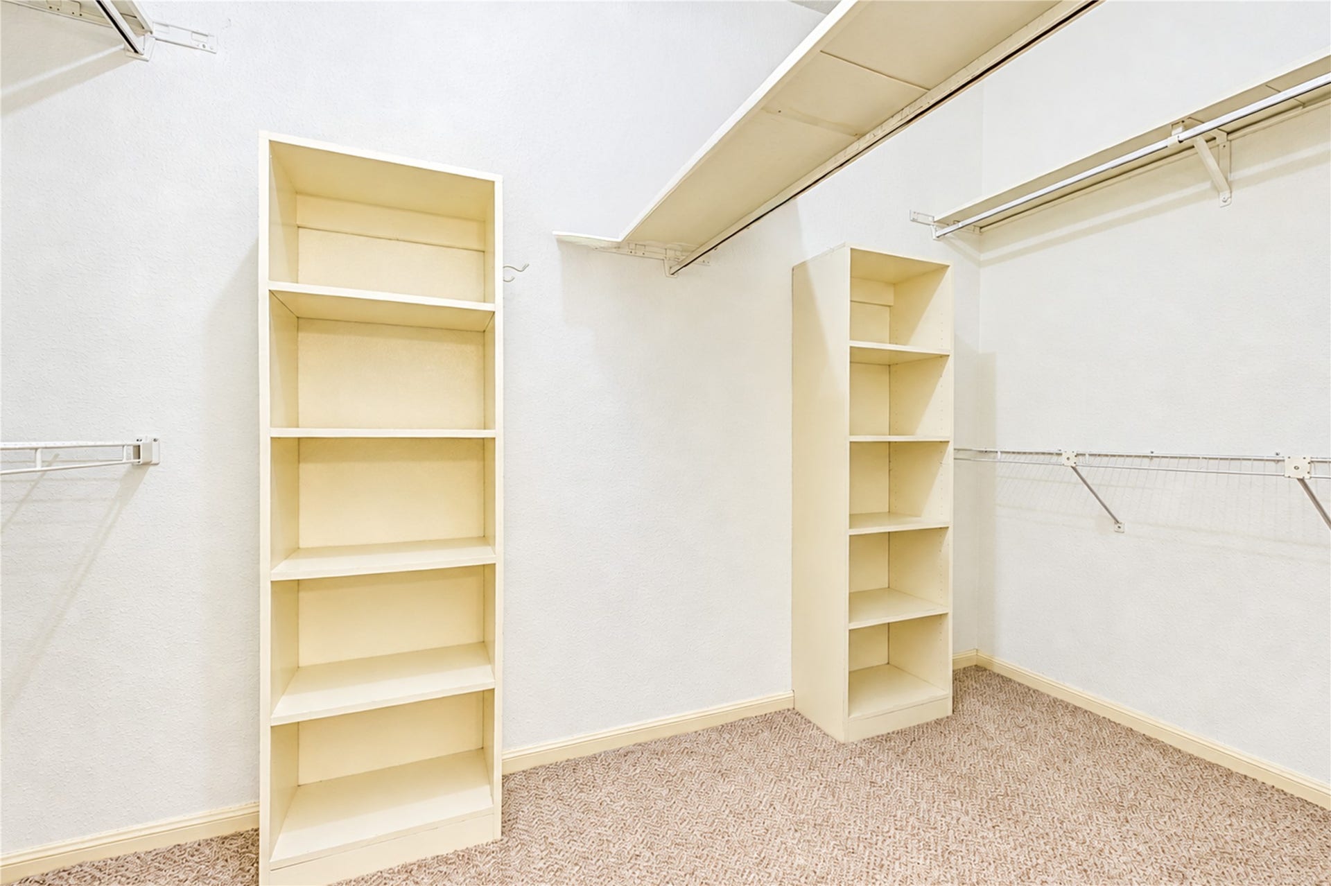 Spacious walk-in closet featuring ample shelving and hanging space for organized storage
