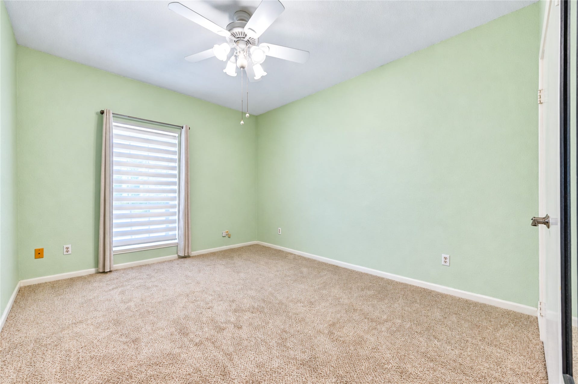 Spacious bathroom featuring a luxurious granite countertop, elegant lighting, and a classic tiled shower with a built-in niche for convenience.