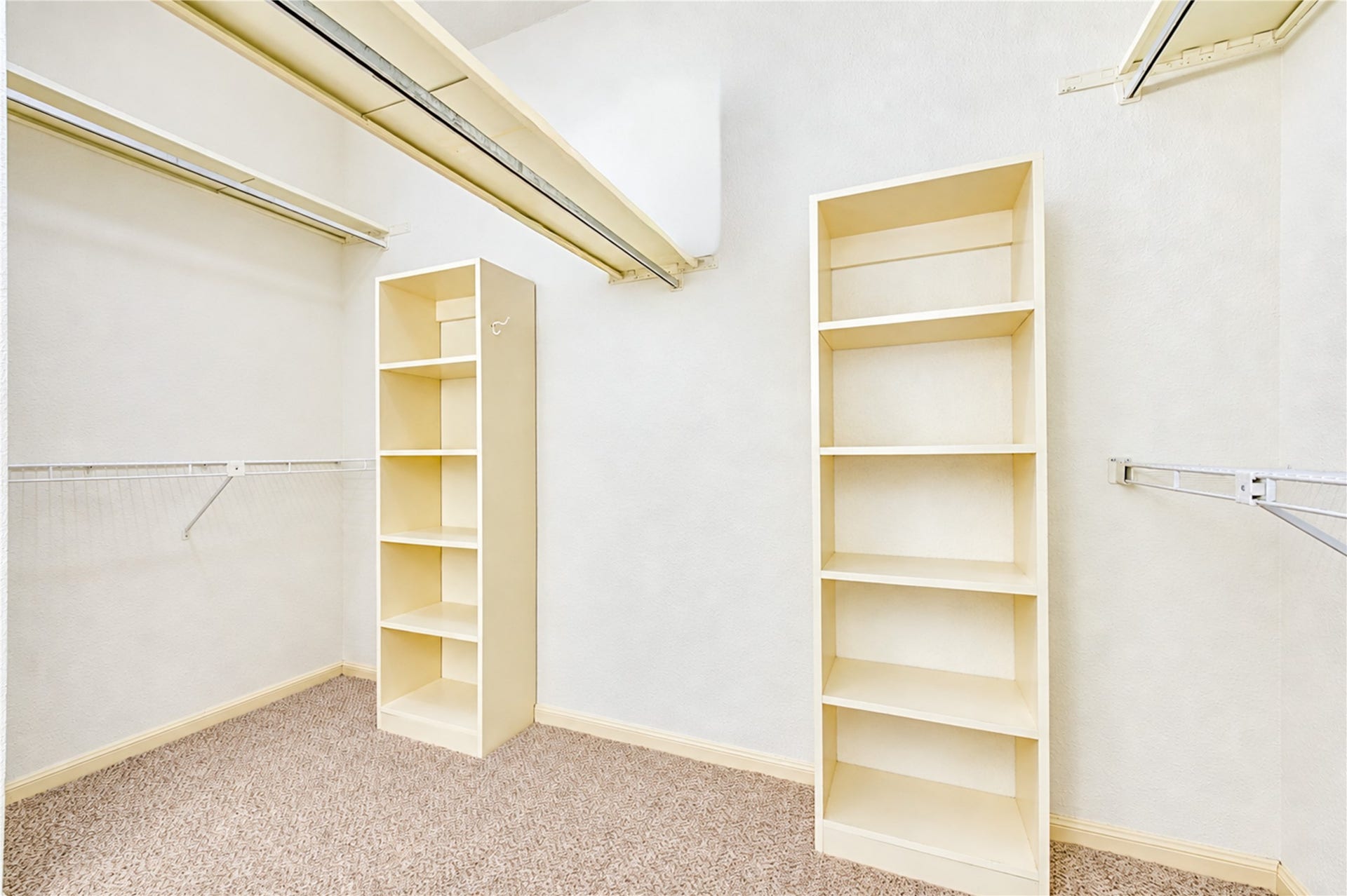 Spacious walk-in closet featuring ample shelving and hanging space for organized storage
