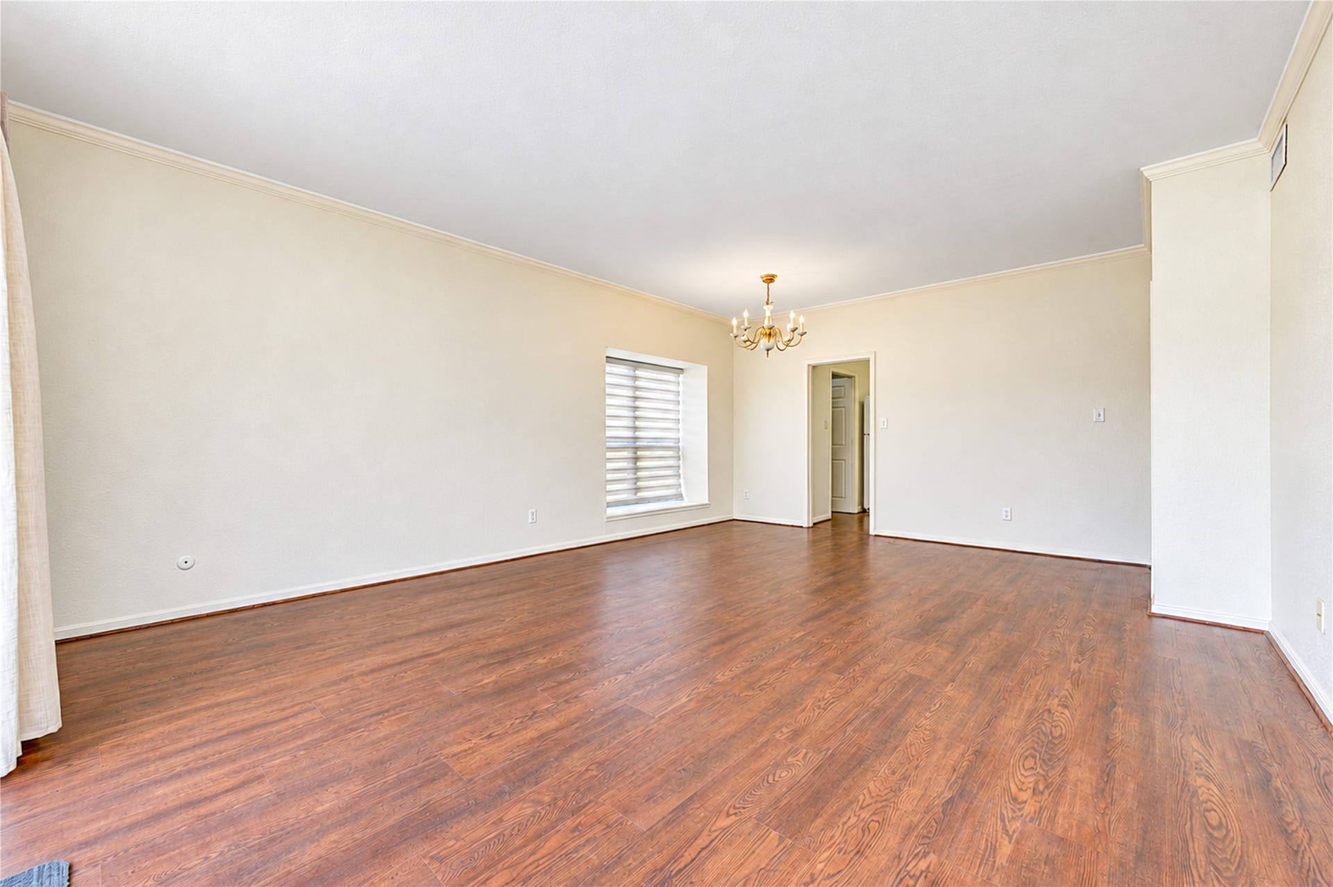 Spacious bedroom with soft green walls, plush carpeting, a ceiling fan, and ample closet space for comfortable living.