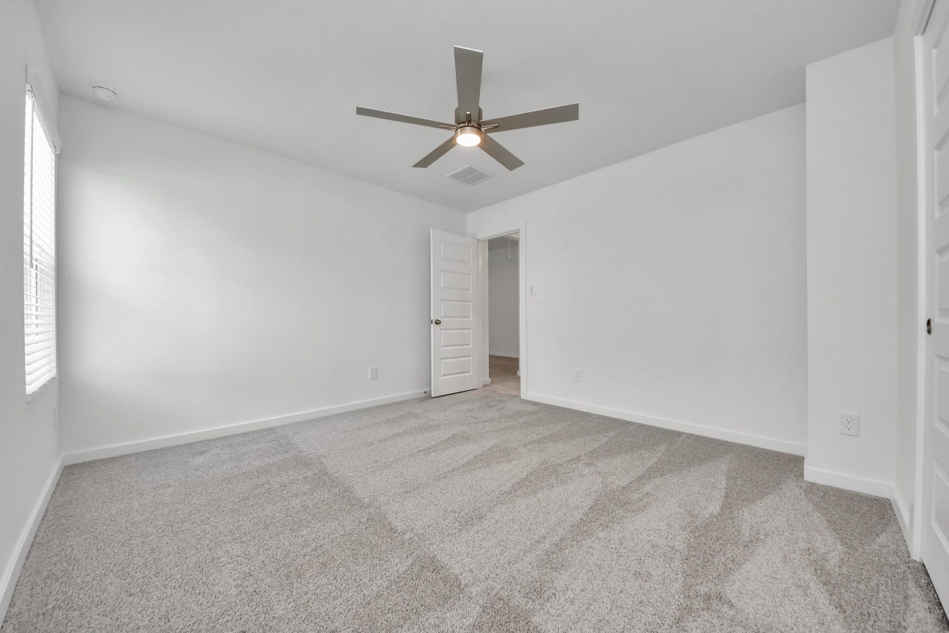 14702 Freestone Plum Court, Houston, TX 77049 Generously sized secondary bedrooms featuring spacious closets, soft and inviting carpeting underfoot, large windows allowing plenty of natural light, and the added touch of privacy blinds for your personal retreat. Sample photo of completed home with similar floor plan. Actual colors and selections may vary.