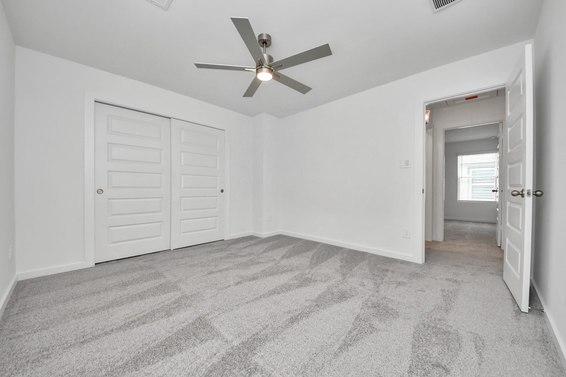 14702 Freestone Plum Court, Houston, TX 77049 Generously sized secondary bedrooms featuring spacious closets, soft and inviting carpeting underfoot, large windows allowing plenty of natural light, and the added touch of privacy blinds for your personal retreat. Sample photo of completed home with similar floor plan. Actual colors and selections may vary.