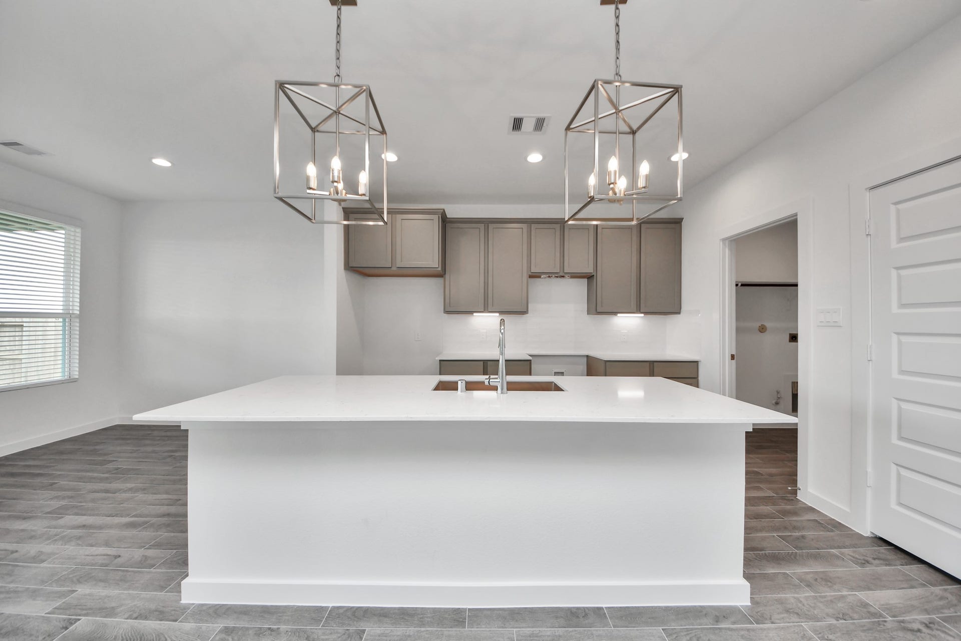 14702 Freestone Plum Court, Houston, TX 77049 This kitchen is by far any chefs dream! This spacious kitchen features high ceilings, light stained wood cabinets, granite countertop, SS appliances, modern tile backsplash, recessed lighting, extended counter space, granite kitchen island with double sink, and space for breakfast bar, and a walk-in pantry all overlooking your huge family room. Sample photo of completed home with similar floor plan. Actual colors and selections may vary.