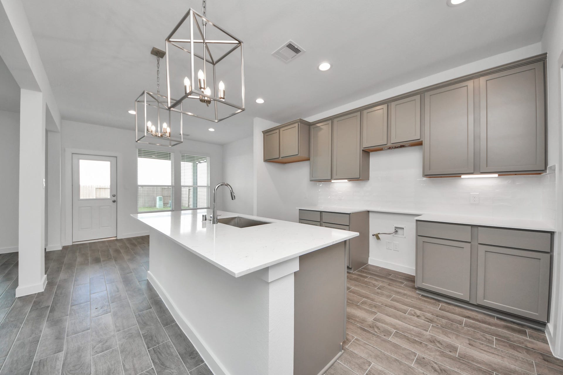 14702 Freestone Plum Court, Houston, TX 77049 The extended counter area adds both practicality and style, making meal preparation a breeze. Every detail is thoughtfully designed to enhance the kitchen's functionality and aesthetic appeal. Sample photo of completed home with similar floor plan. Actual colors and selections may vary.