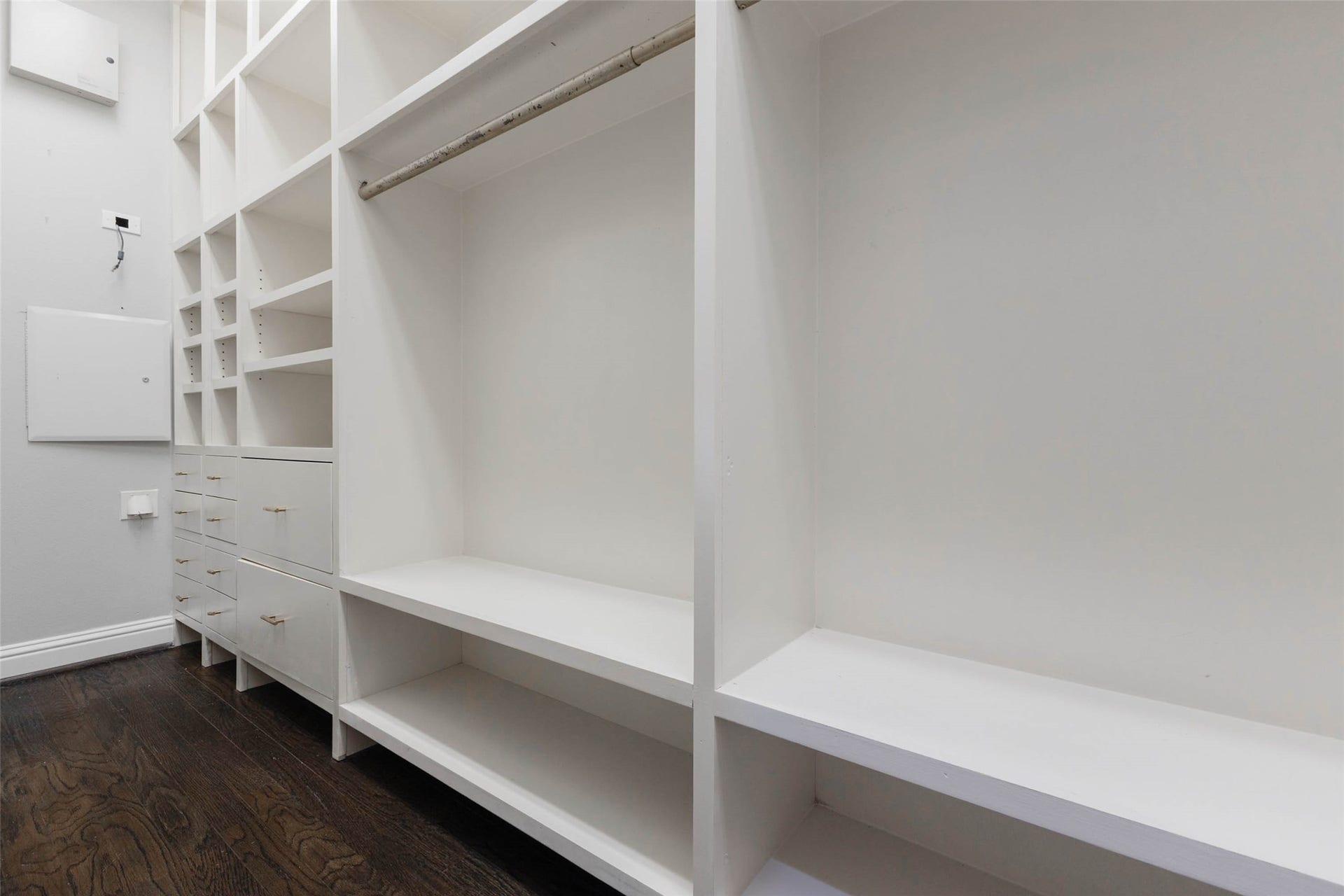 Custom built primary closet with lots of drawers for shelves for storage. So PERFECT!