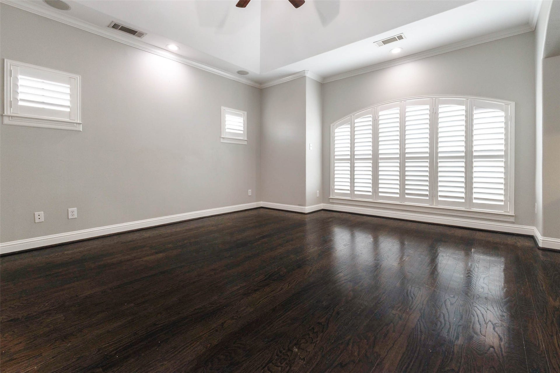 Large bedroom, high ceilings, plantation shutters, tons of natural light, a sitting area, and coffee bar... I mean what more could you ask for in a primary bedroom?