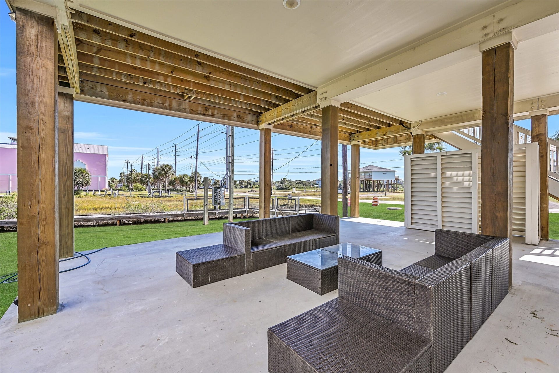 3627 Niko Court, Galveston, TX 77554 The covered ground-level area offers ample space for entertaining guests and additional parking.