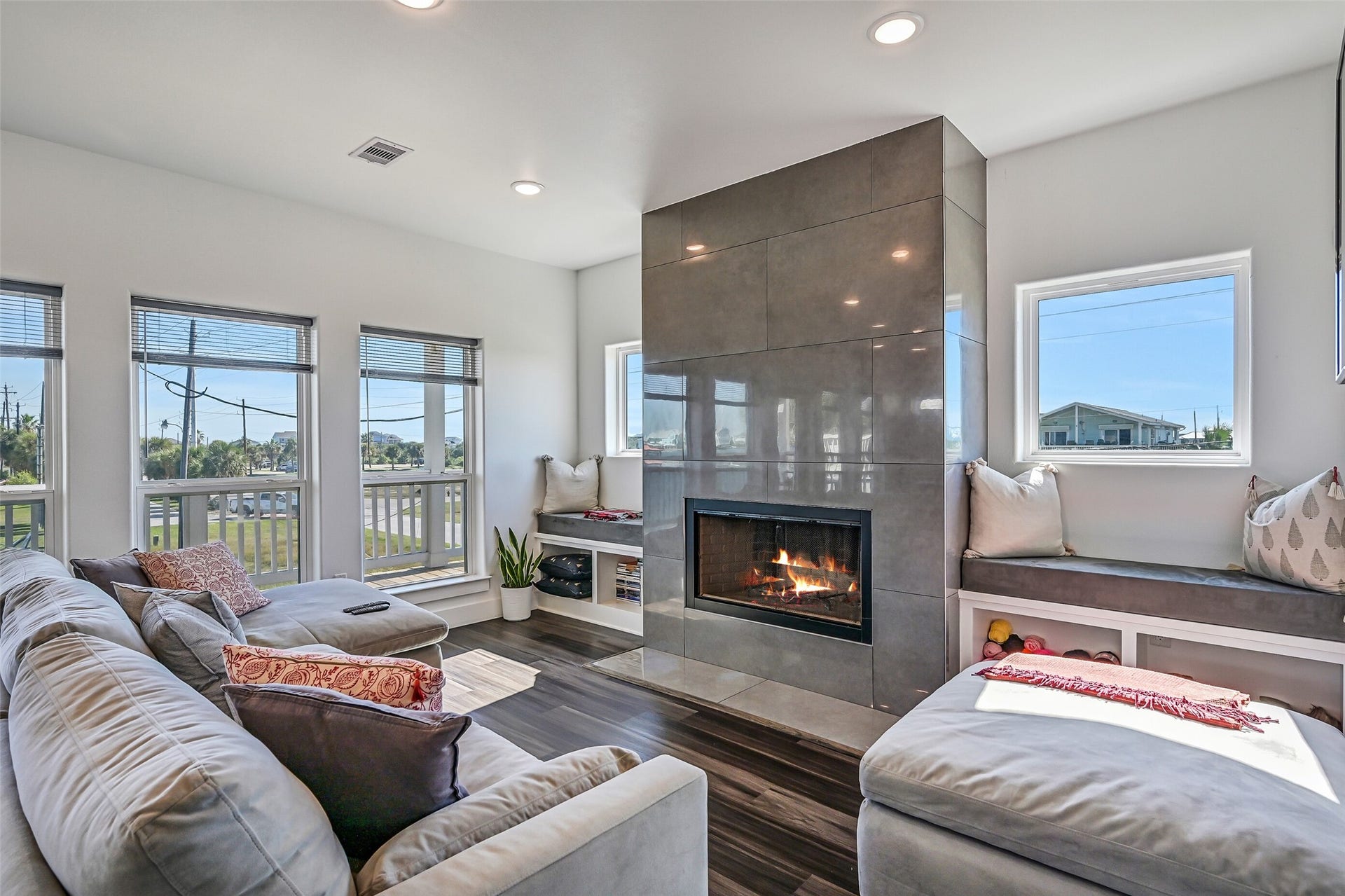 3627 Niko Court, Galveston, TX 77554 The spacious living room offers the perfect place to unwind or entertain, complete with a cozy wood-burning fireplace.