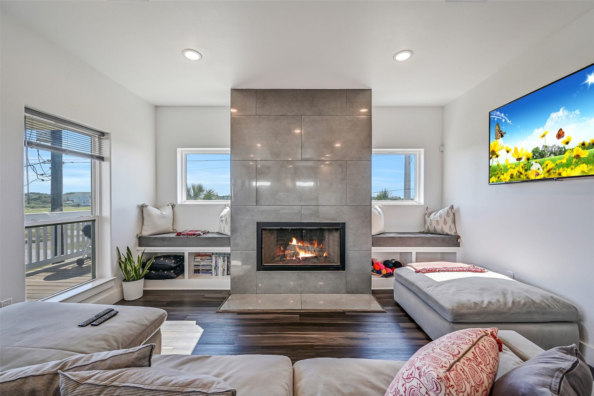 3627 Niko Court, Galveston, TX 77554 Built-in seating flanks both sides of the wood-burning fireplace, adding charm and functionality to the living space.