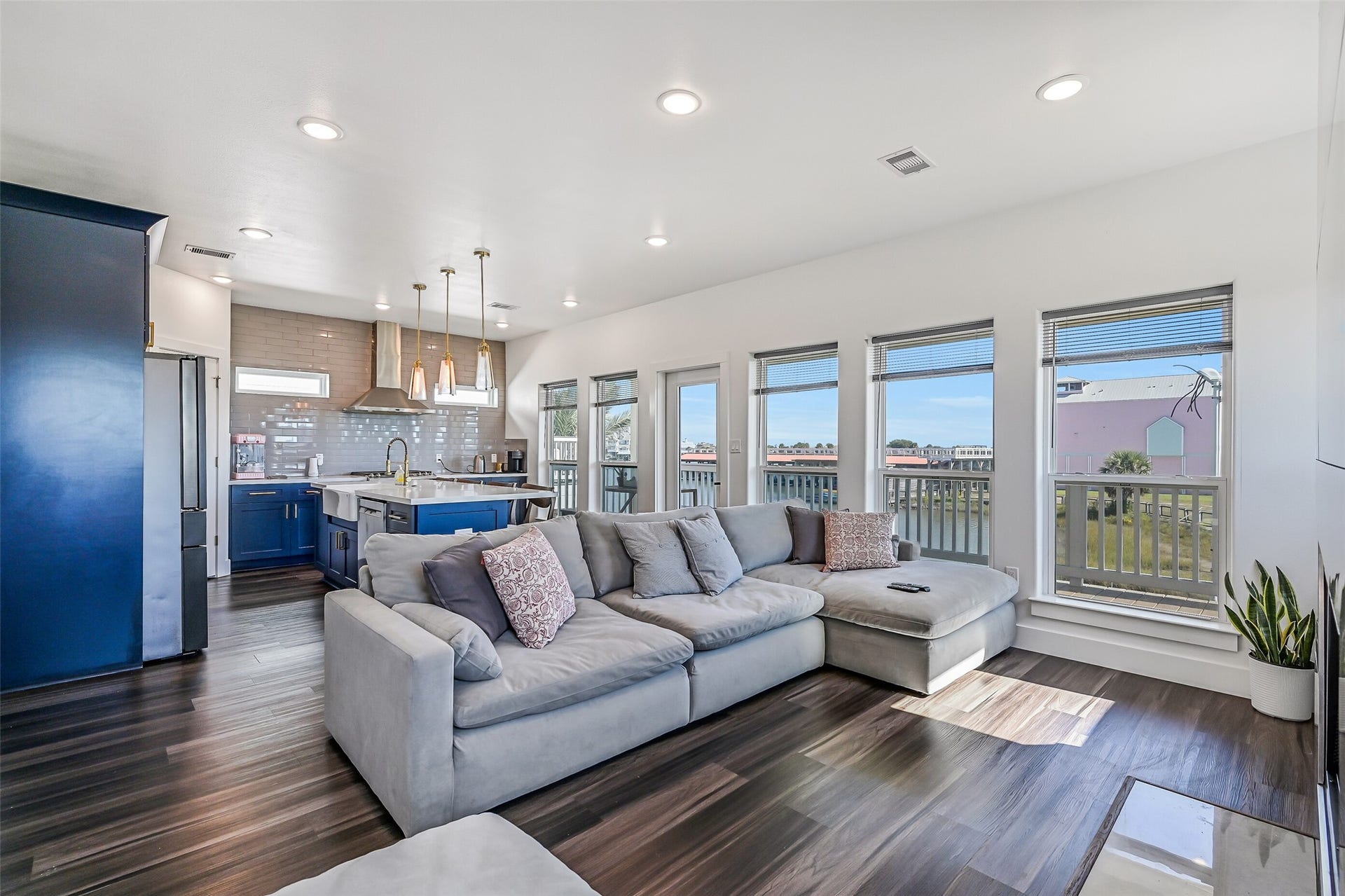 3627 Niko Court, Galveston, TX 77554 Walls of windows fill the home with natural light, while beautiful vinyl plank flooring flows throughout.