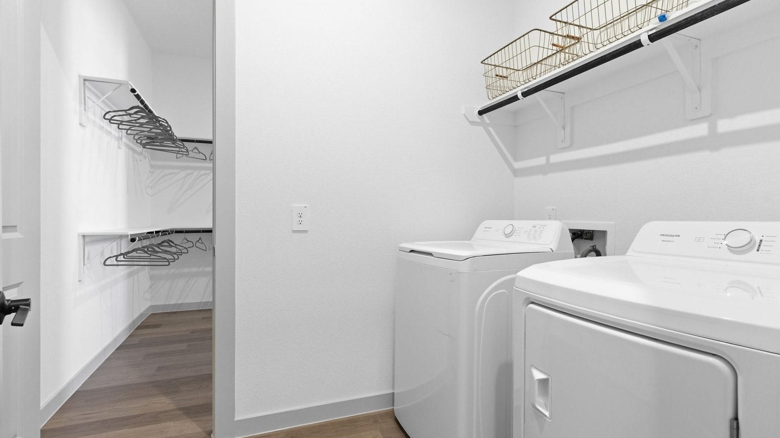 2507 Friendswood Trail, Friendswood, TX 77546 A laundry room featuring washer and dryer connections, neatly arranged with ample space for laundry tasks, and storage.