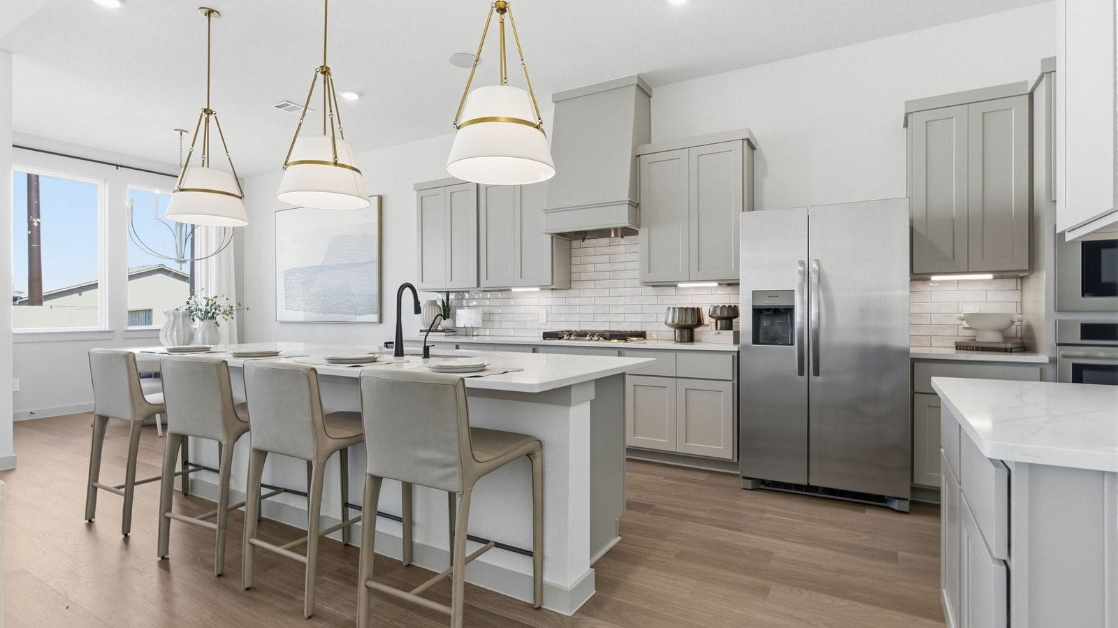 2507 Friendswood Trail, Friendswood, TX 77546 Luxurious and spacious kitchen with quartz countertops, stainless steel appliances, painted cabinets, expansive storage and an island with bar seating.