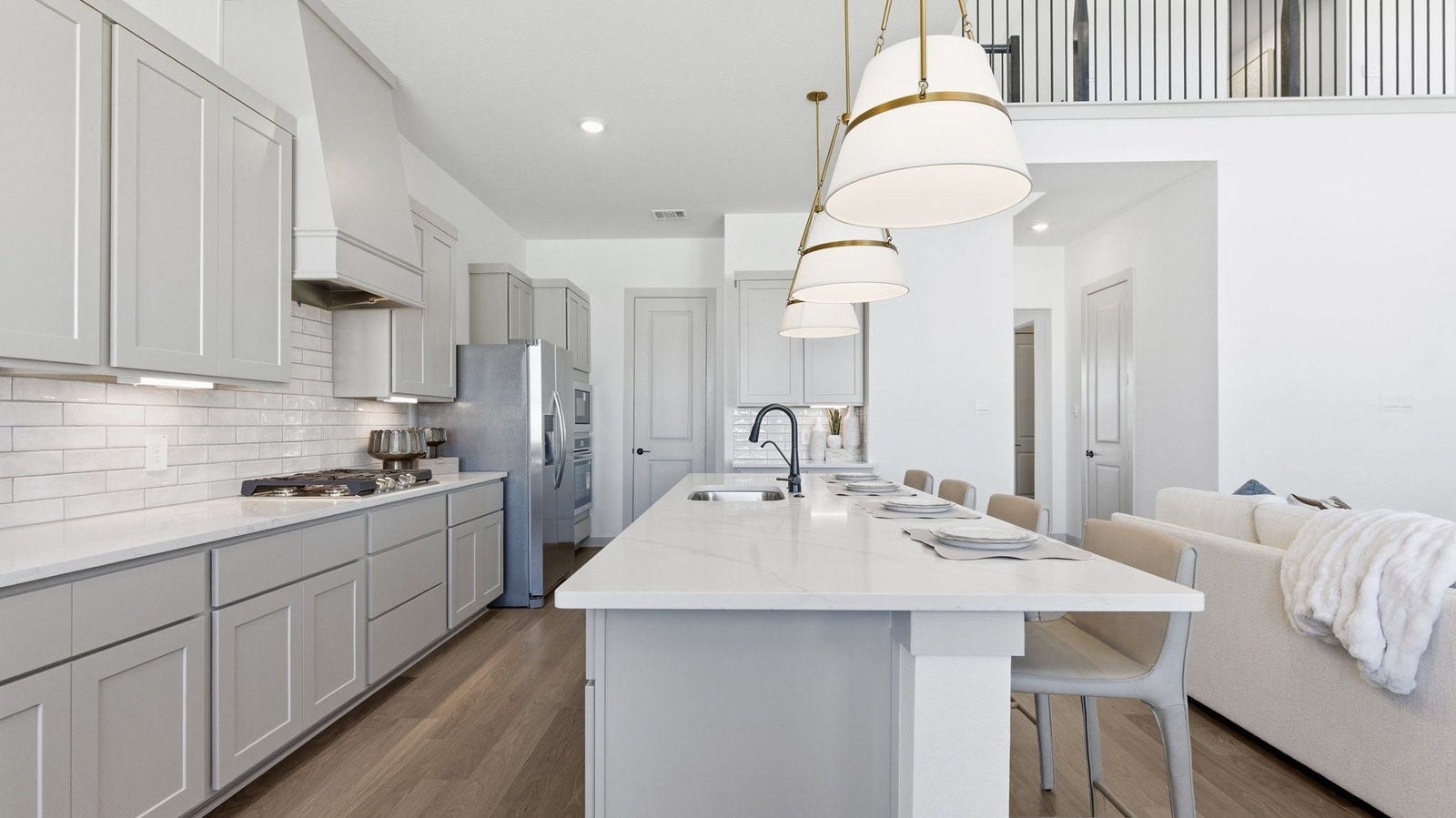 2507 Friendswood Trail, Friendswood, TX 77546 Kitchen adorned with painted cabinets seamlessly integrated into an open dining area layout.