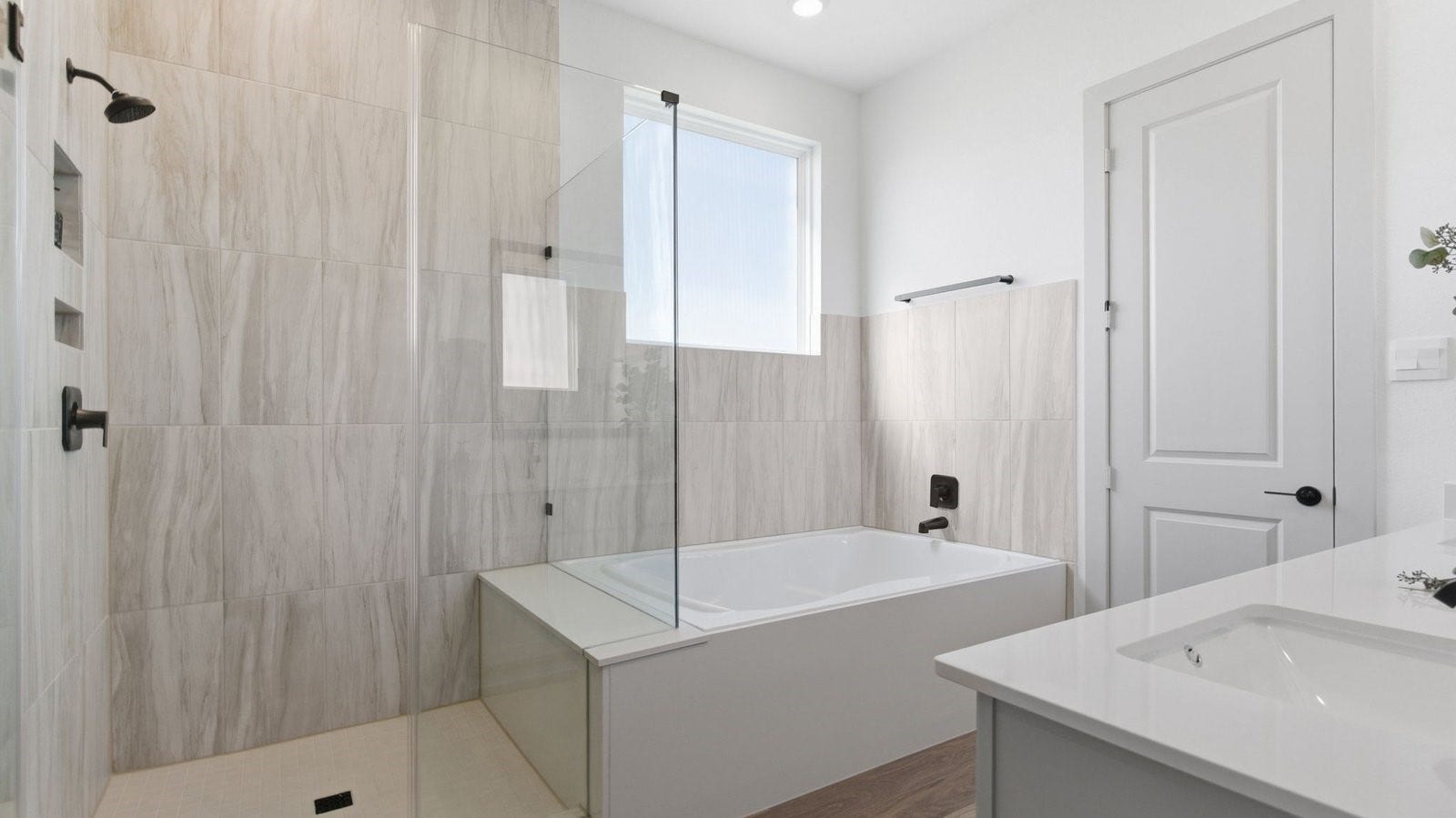 2507 Friendswood Trail, Friendswood, TX 77546 Primary bathroom with a glass-enclosed standing shower and separate soaking tub.