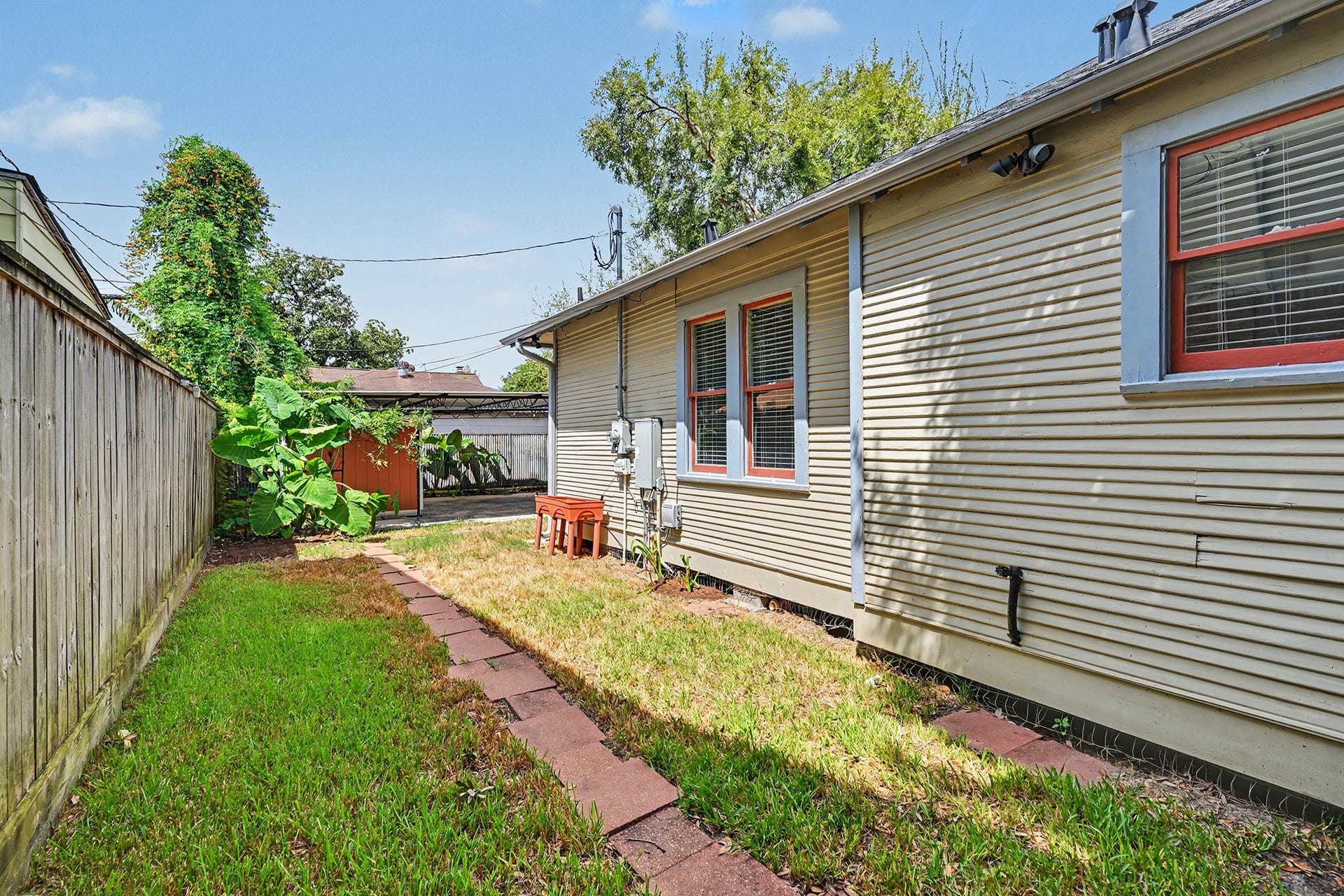 Walkway leads through the side yard, providing convenient access along the home.