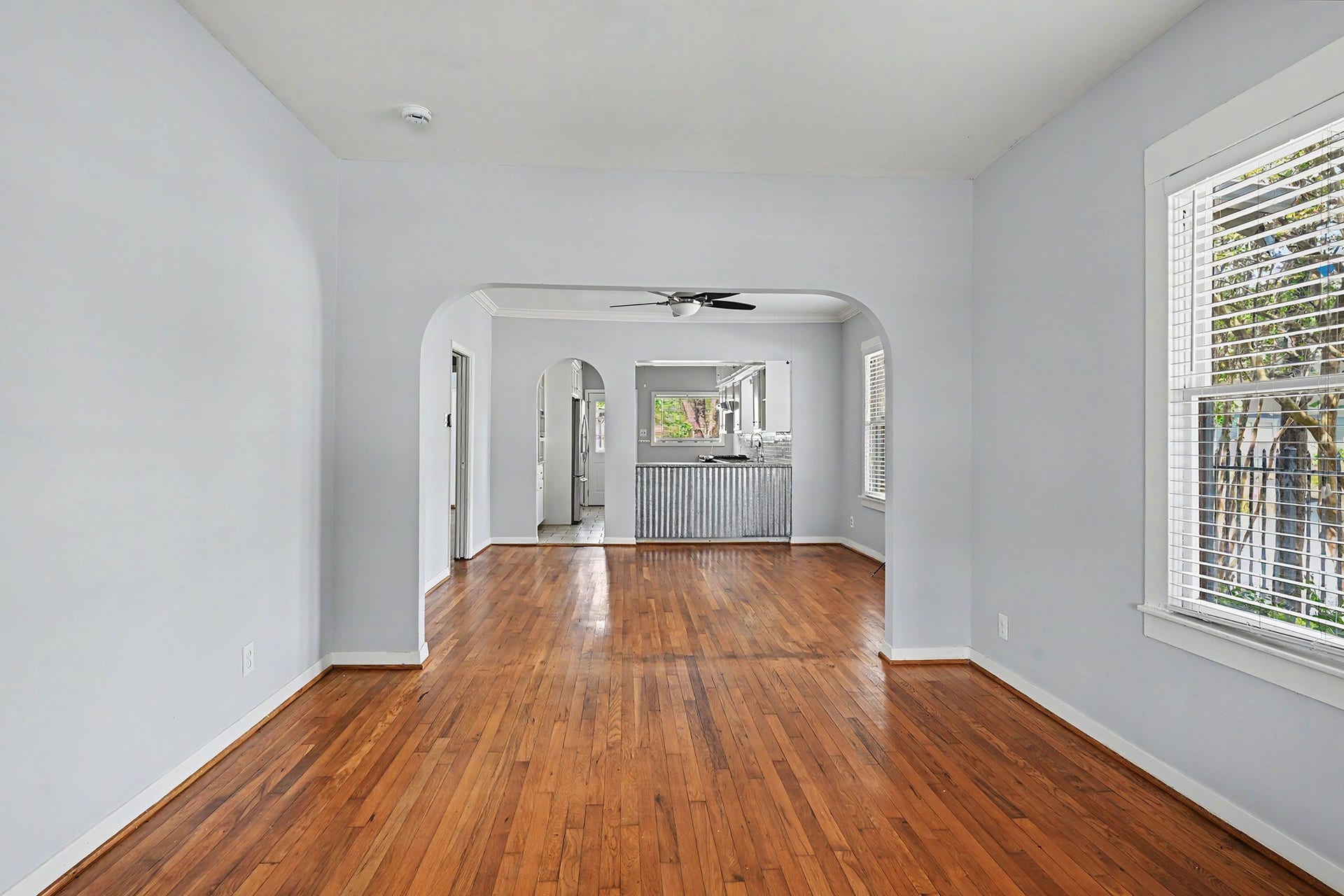 View from the living room toward the dining room and kitchen showcases an open layout with defined spaces.