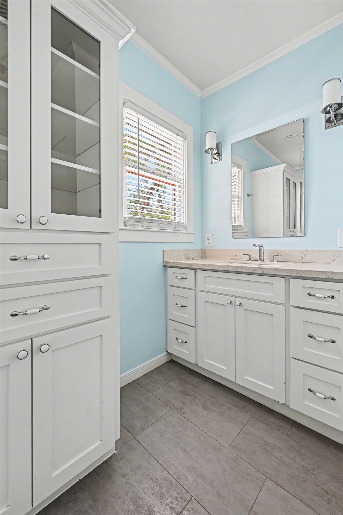 Built-in storage and a spacious vanity with ample drawers provide convenient organization for linens, toiletries, and everyday essentials.