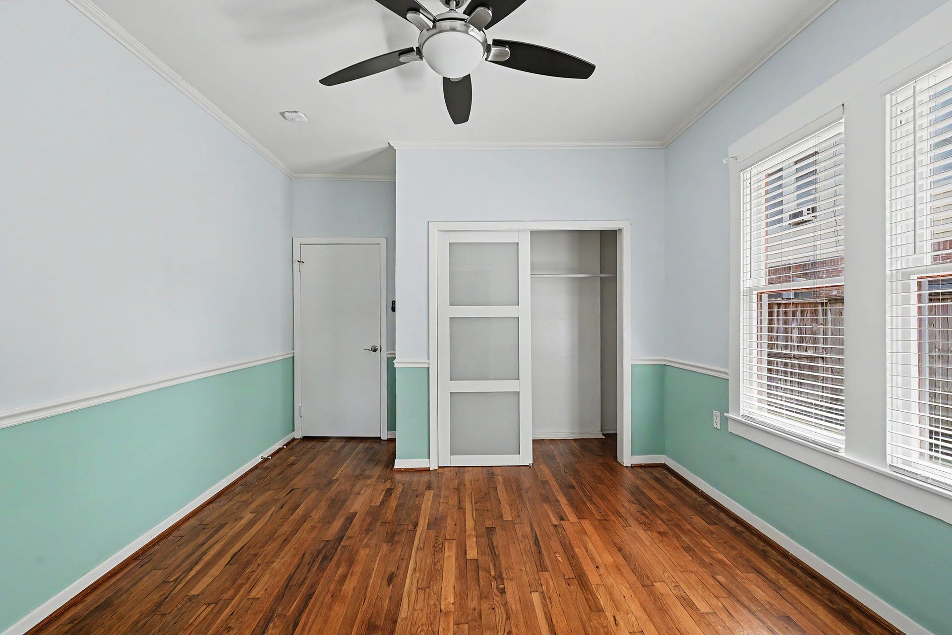 View of the primary bedroom highlights the closet and trimwork.