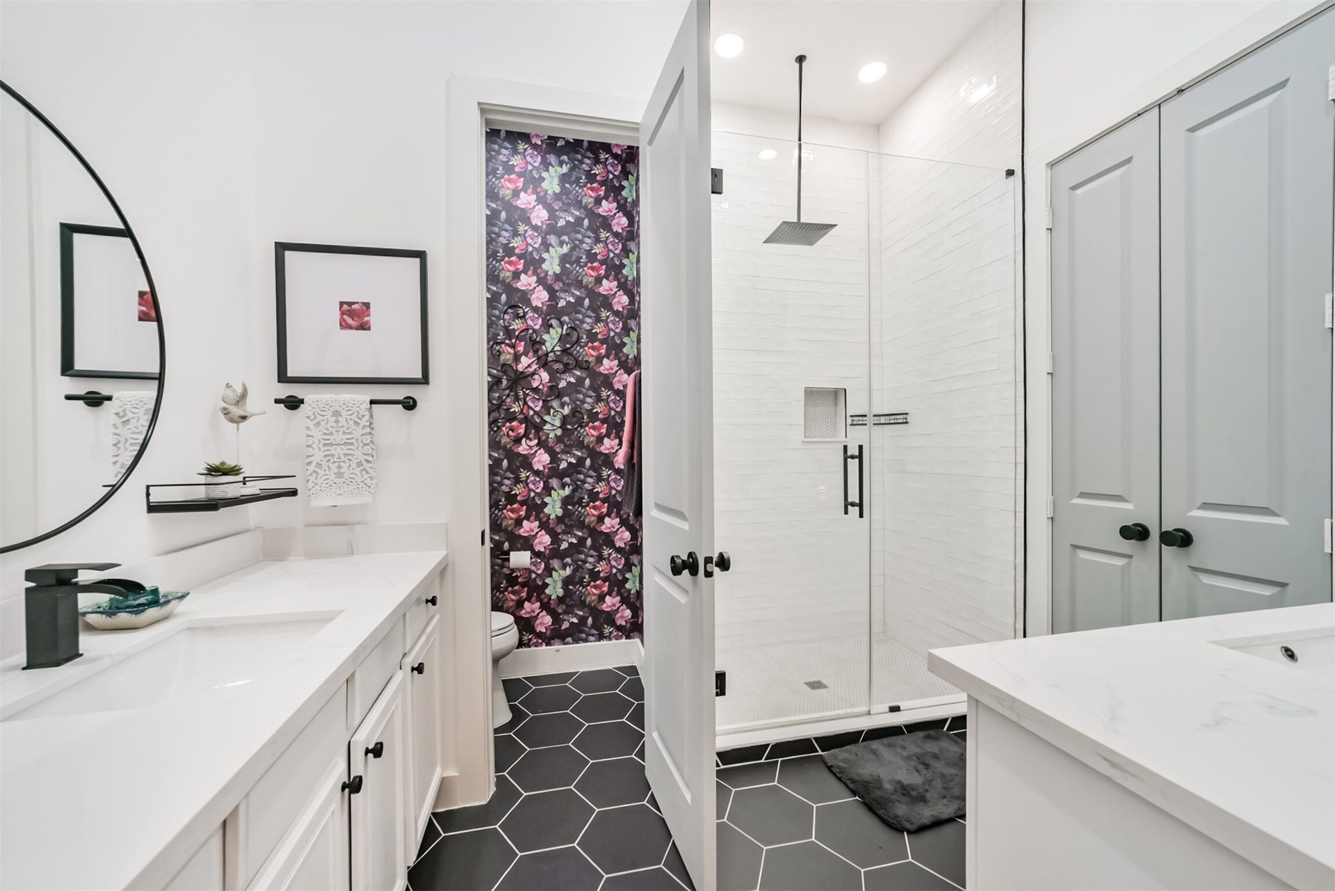1721 W 24th Street, Houston, TX 77008 Spa-like primary bath with double sinks, quartzite counters, artisan tile surround, a rain shower and a showstopping floral wallpaper accent in water closet!