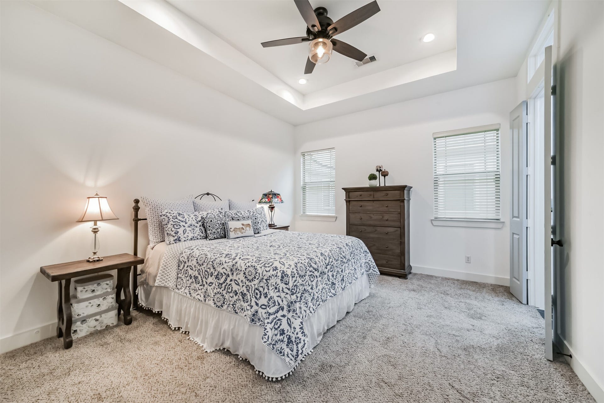 1721 W 24th Street, Houston, TX 77008 Spacious primary suite with a tray ceiling and two sunny windows, a peaceful place to unwind