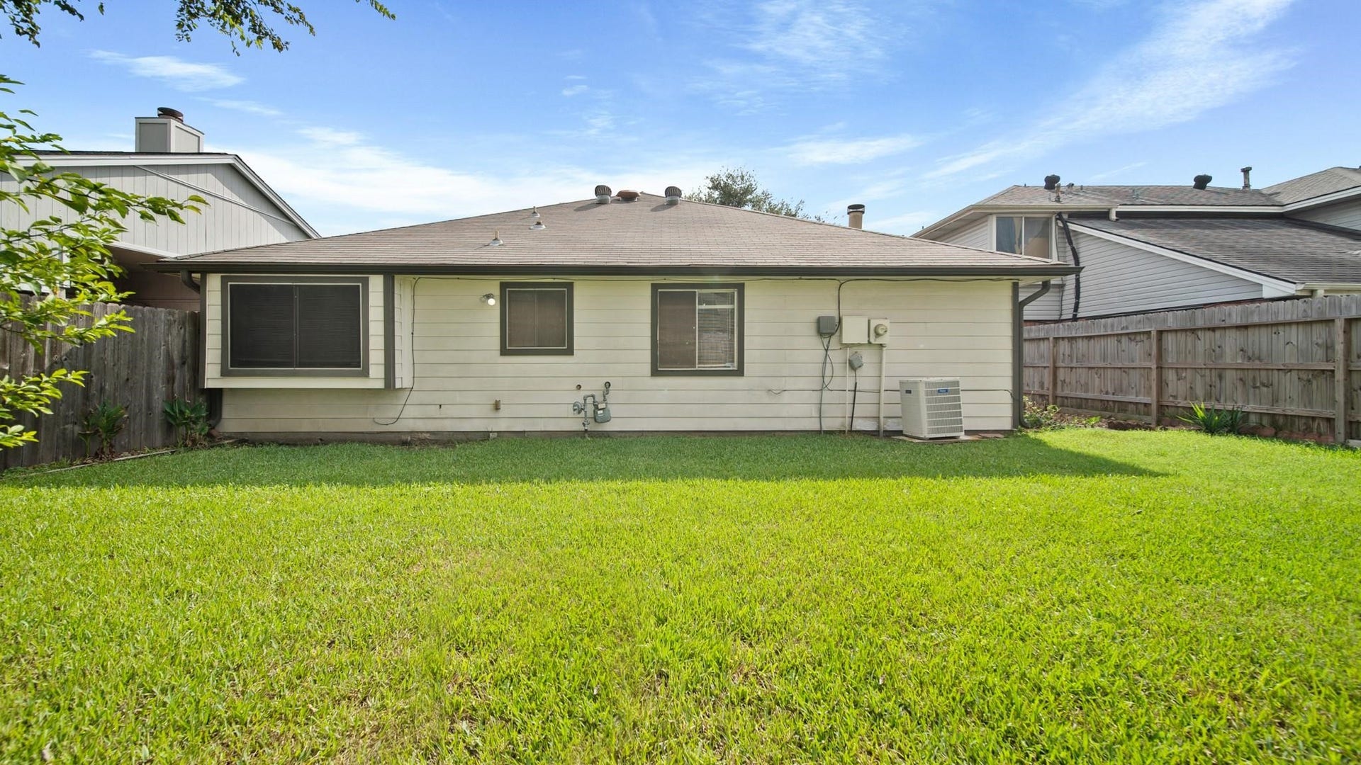 2012 Sandy Knoll Drive, Missouri City, TX 77489 Rear exterior view showcasing the spacious, fully fenced backyard.