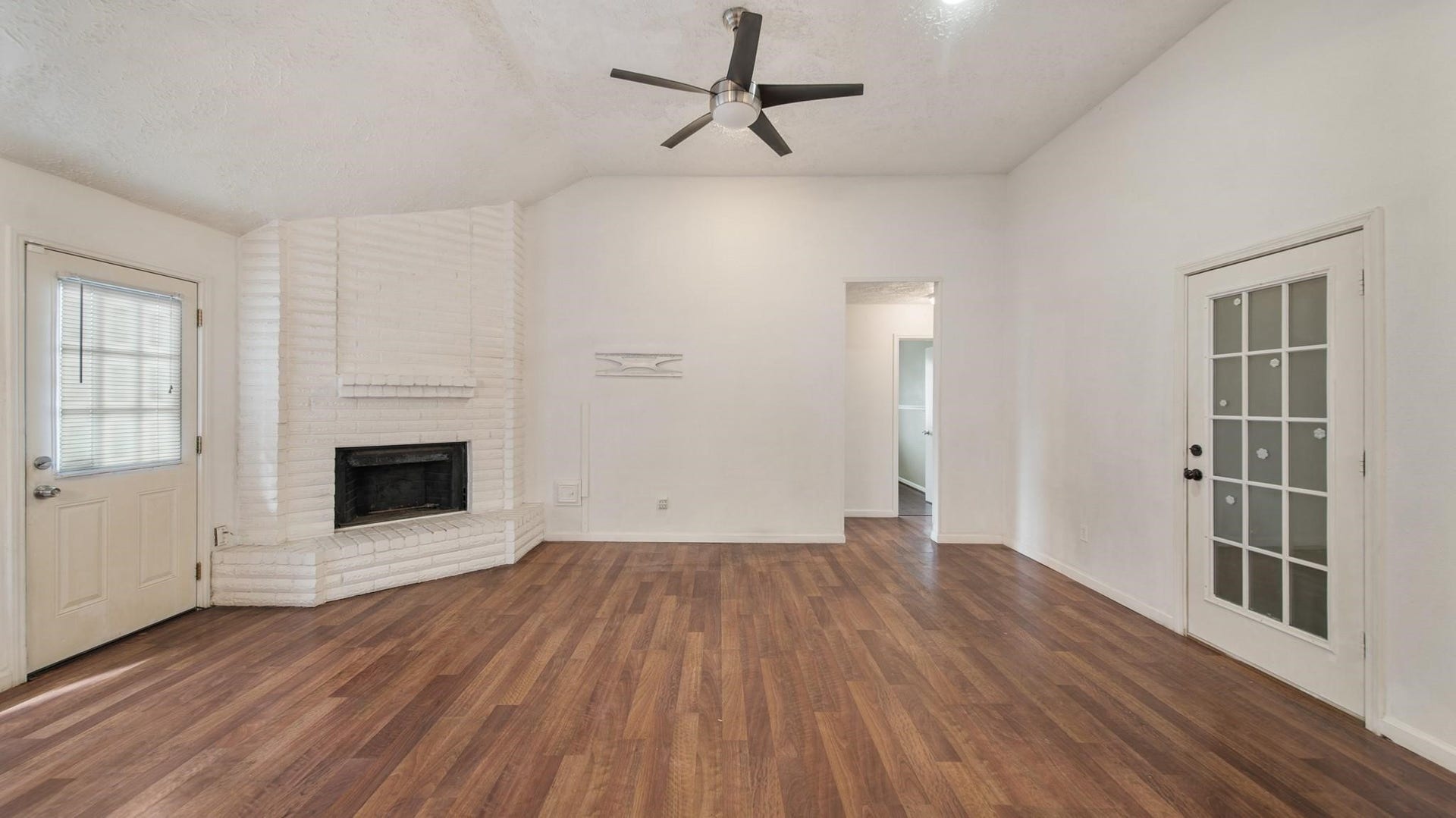 2012 Sandy Knoll Drive, Missouri City, TX 77489 Spacious living room featuring wood flooring, a fireplace, and ceiling fan.