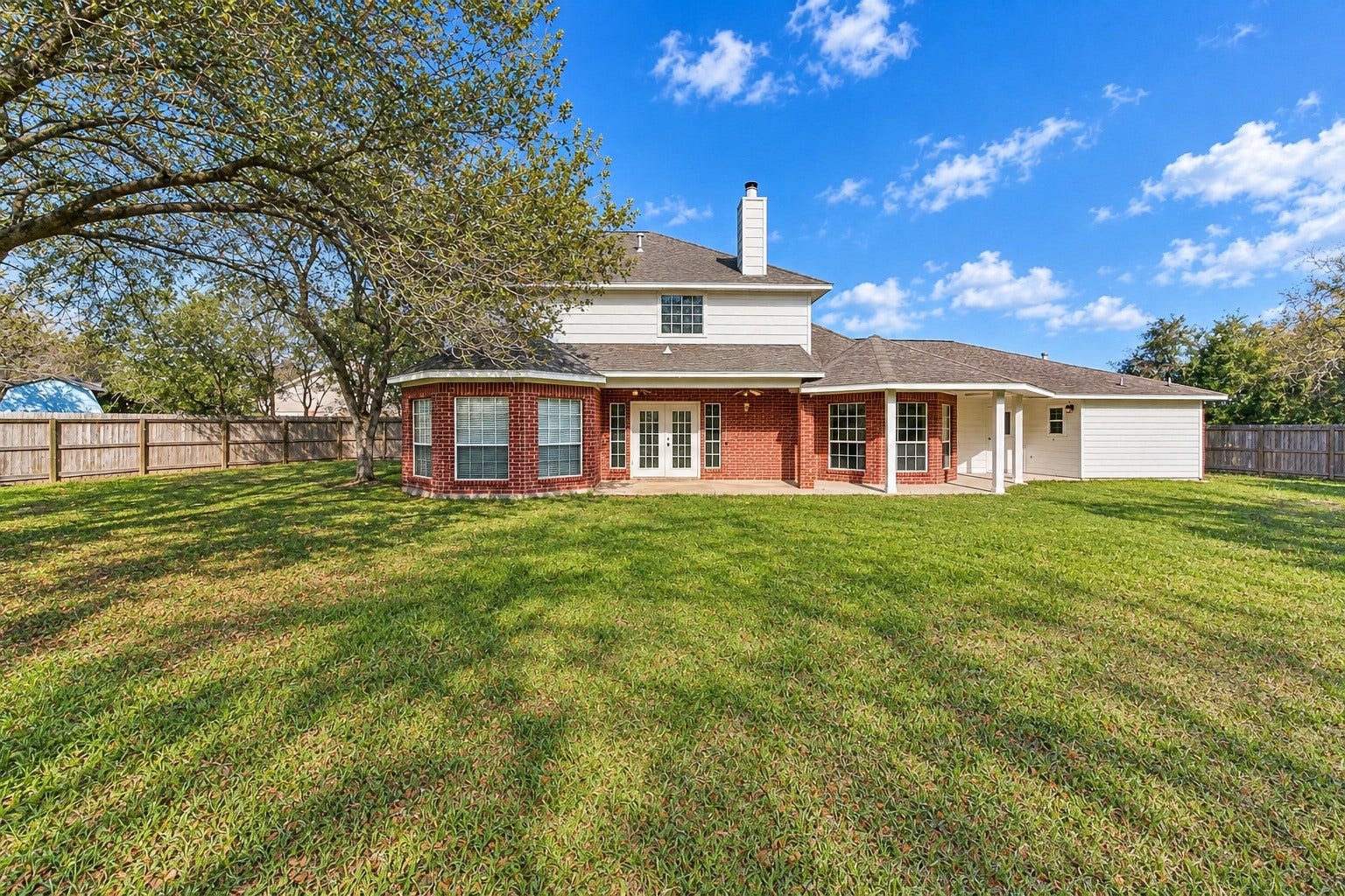 4030 Larkspur Street, Alvin, TX 77511 Charming home with a stylish brick exterior and a welcoming covered walkway, perfect for enjoying the outdoors.