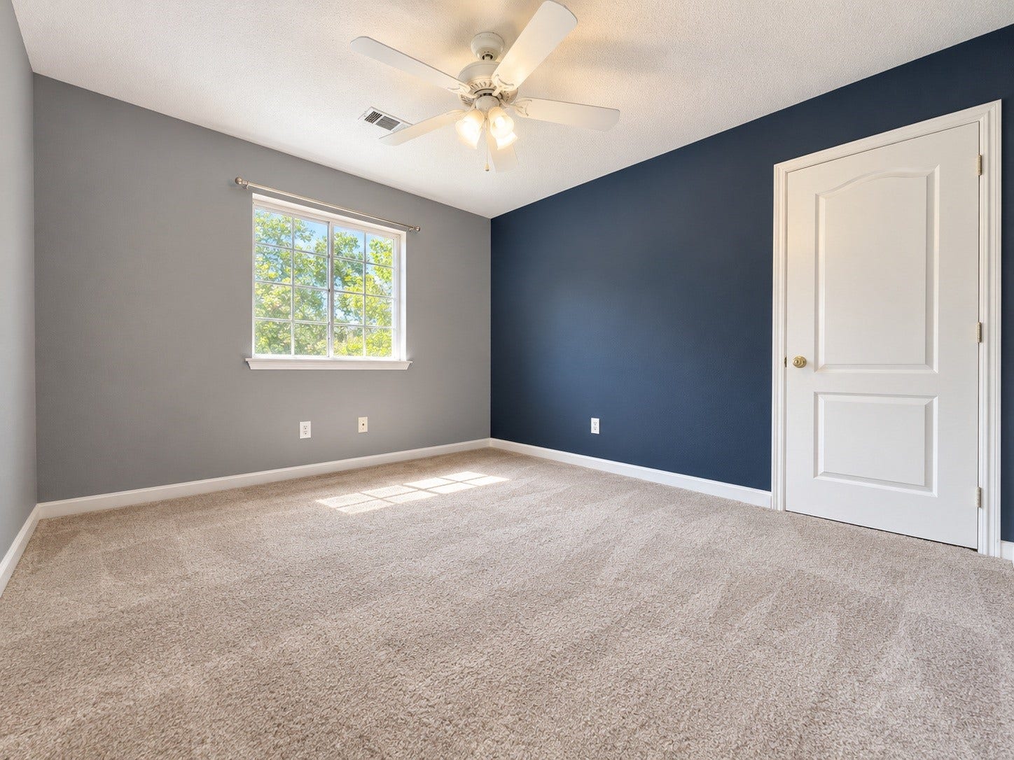 4030 Larkspur Street, Alvin, TX 77511 Spacious bedroom featuring plush carpeting, a modern ceiling fan, and abundant natural light through a large window.