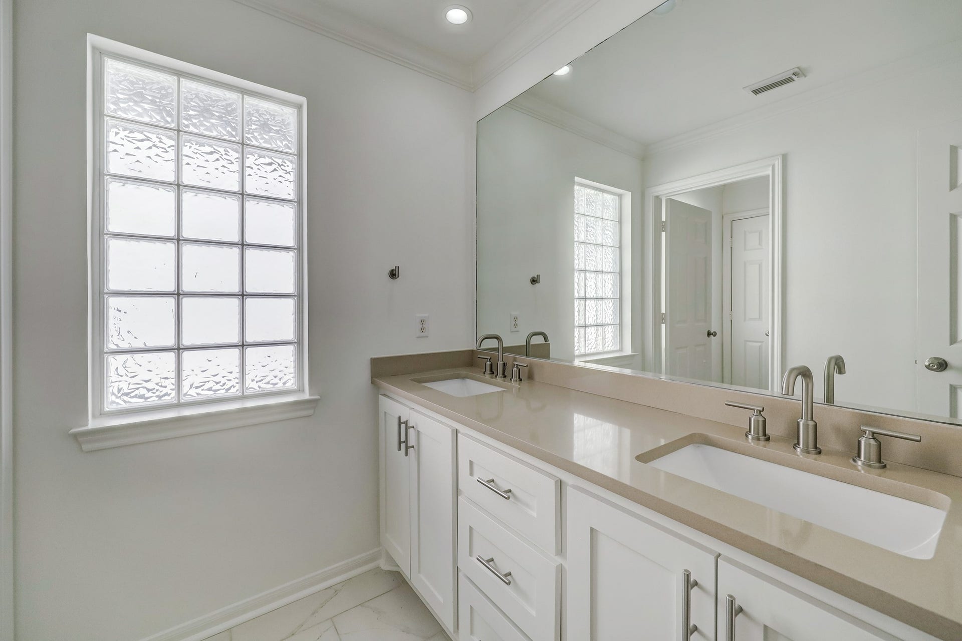 3608 Timberside Circle Drive, Houston, TX 77025 SECONDARY BATHROOM: Bright and functional with a spacious double vanity, sleek countertops, and contemporary finishesideal for shared use.
