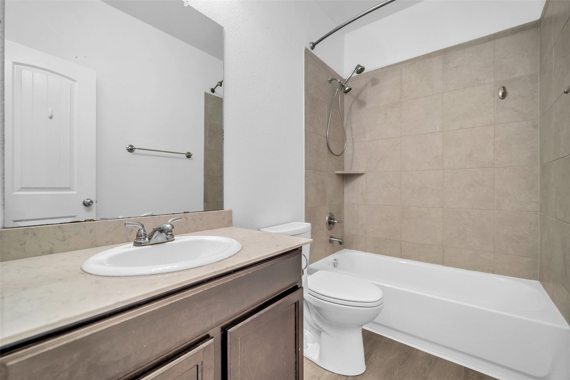 4707 Waukegan Road, Conroe, TX 77306 Secondary bathroom includes a convenient tub and shower combination, providing a practical setup for both quick showers and relaxing baths.