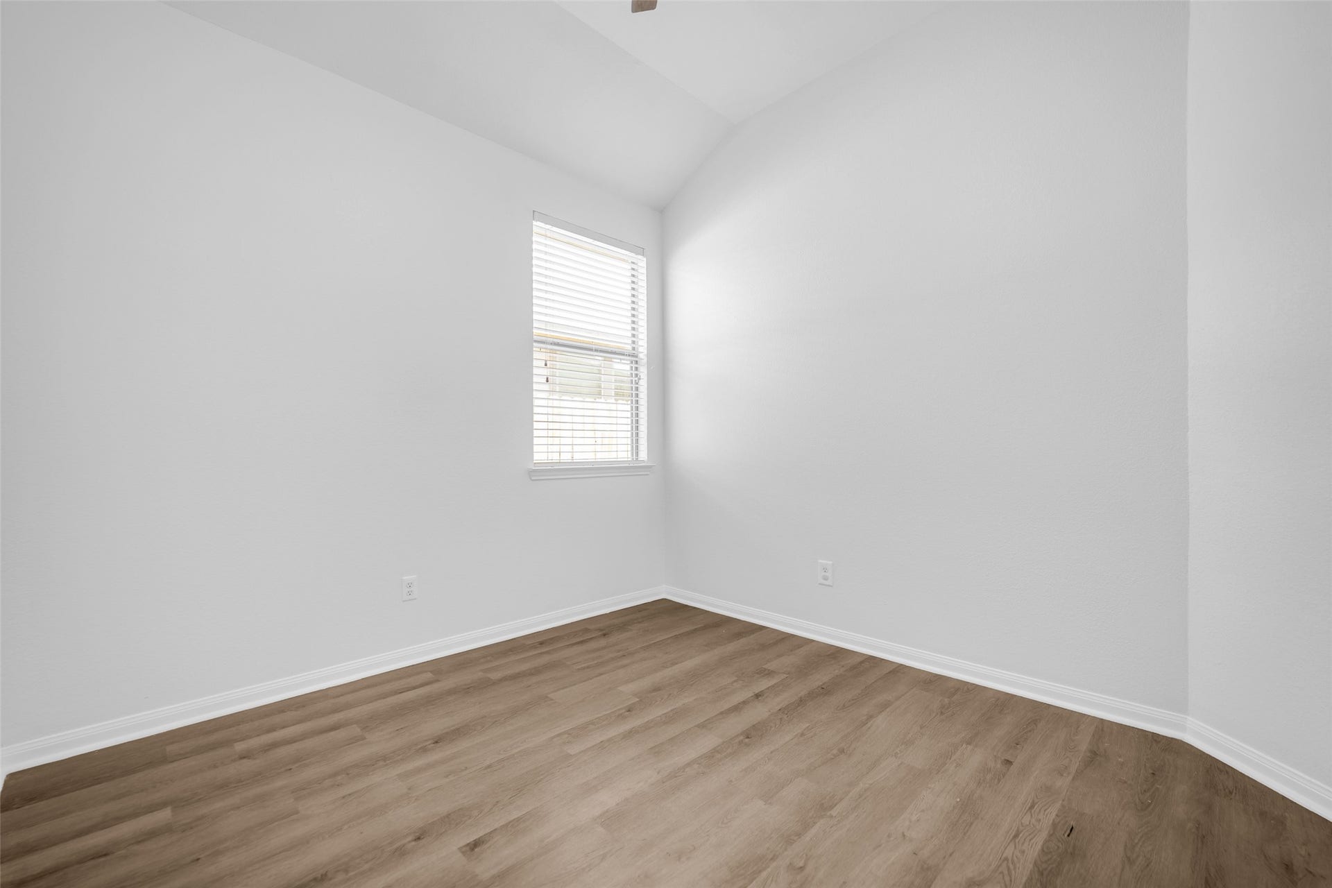 4707 Waukegan Road, Conroe, TX 77306 This additional secondary bedroom features a window with a view of the side yard, along with vinyl flooring and a ceiling fan for everyday comfort.