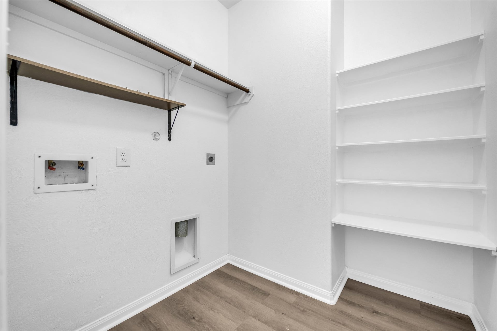 4707 Waukegan Road, Conroe, TX 77306 Laundry room features built-in shelving and hanging racks for convenience.