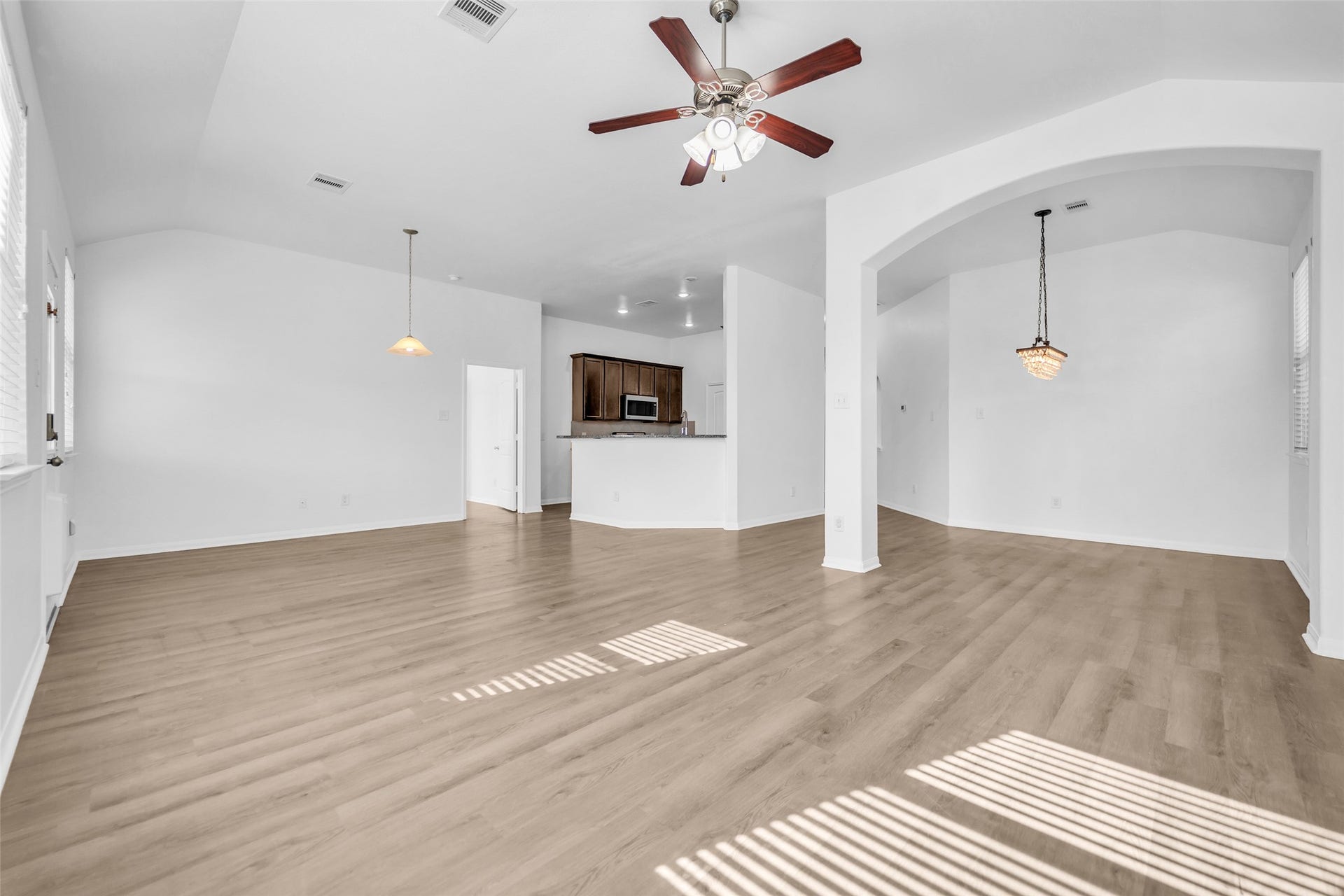 4707 Waukegan Road, Conroe, TX 77306 Unfurnished view of the living room, dining area, and kitchen.