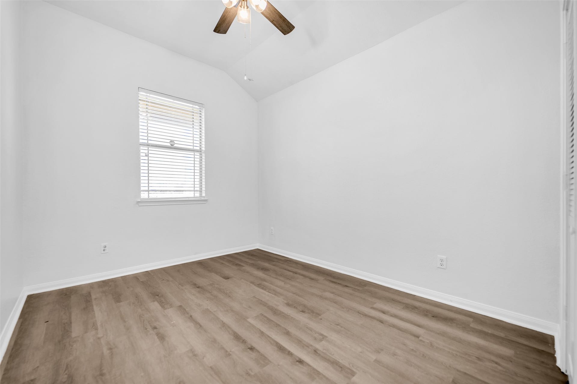 4707 Waukegan Road, Conroe, TX 77306 Secondary bedroom overlooks the front yard and features a ceiling fan for improved airflow, along
with vinyl flooring that adds durability and easy maintenance.