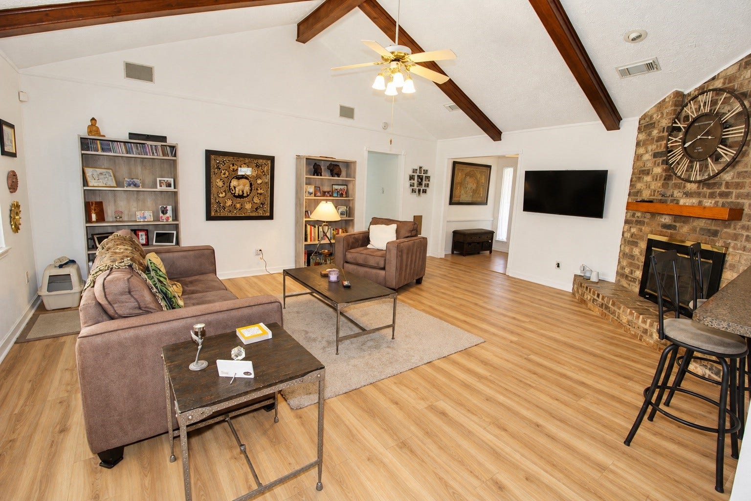 13767 Greywood Drive, Sugar Land, TX 77498 View of the living room featuring a breakfast bar and a cozy fireplace